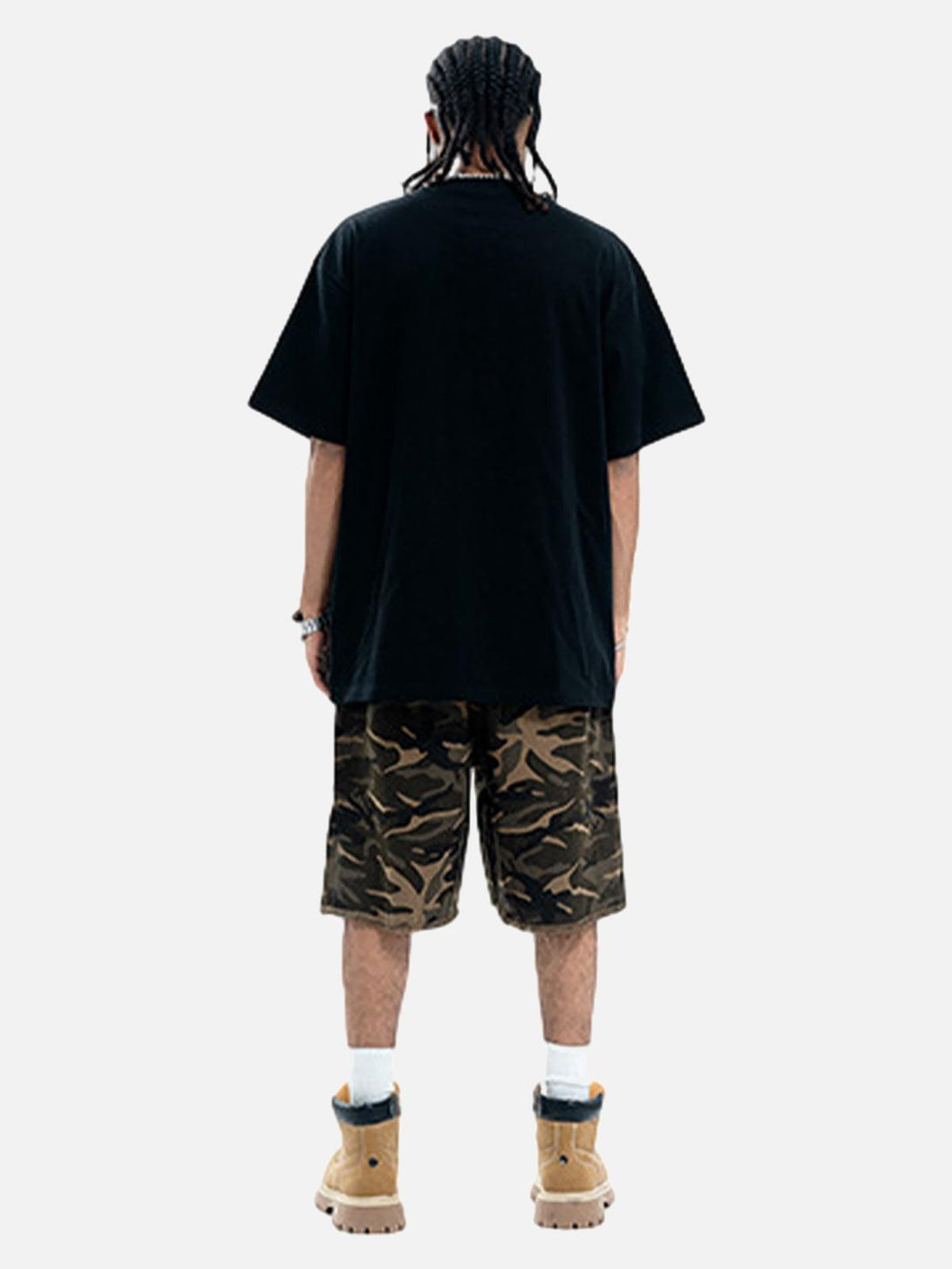 Back view of TALISHKO T-shirt styled with camo shorts and boots, highlighting casual streetwear.