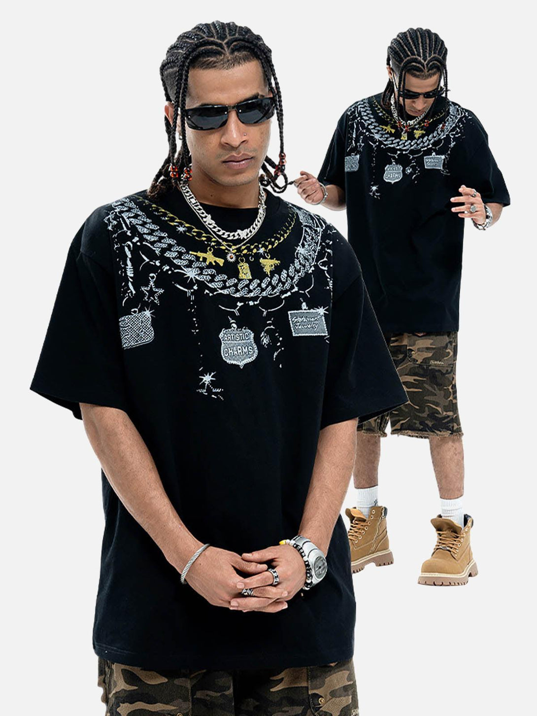 Model styled in TALISHKO chain print T-shirt with camo shorts and boots, exuding urban flair.