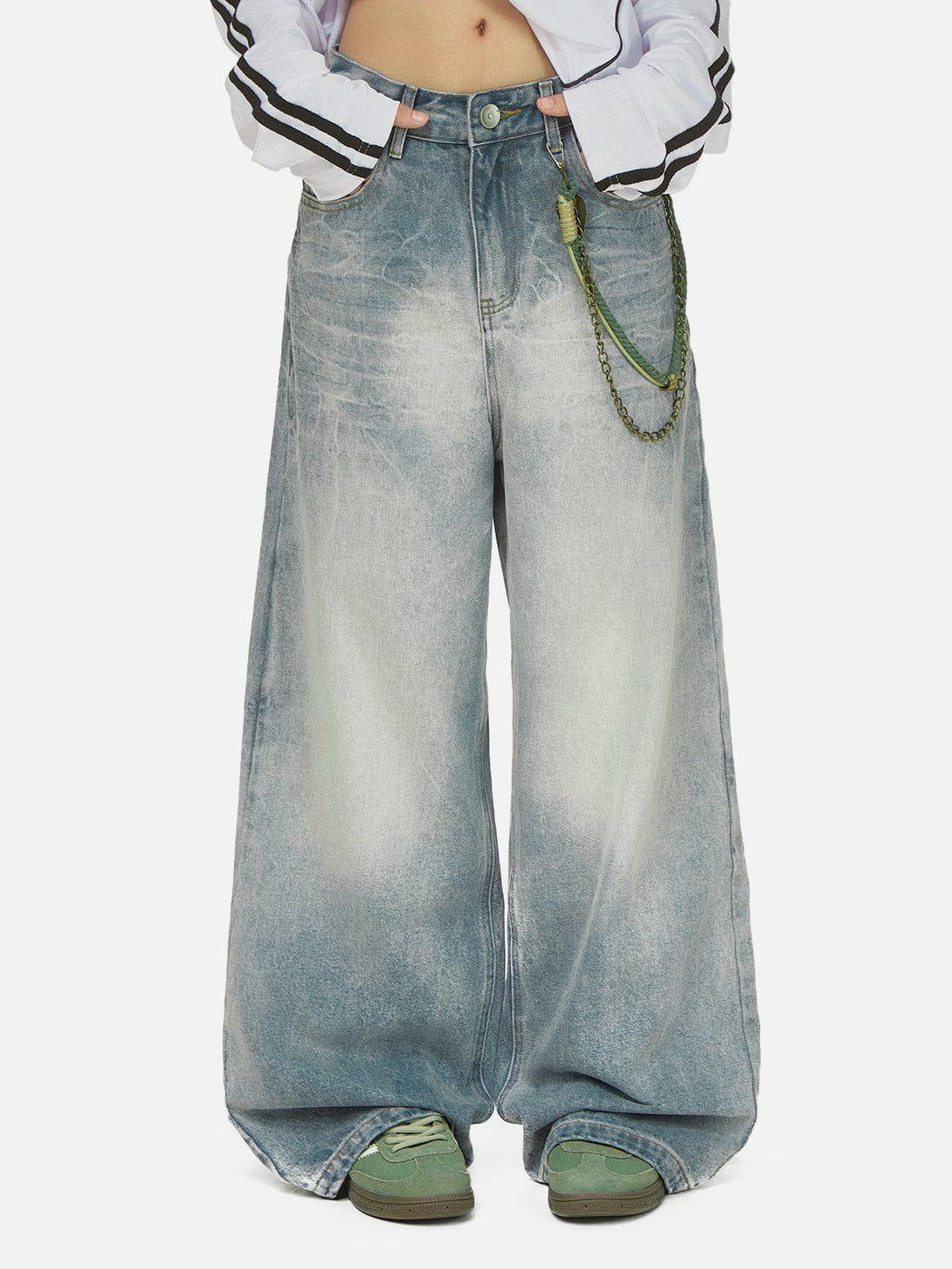 Wide-leg jeans with a washed effect and chain detail, styled casually by TALISHKO.
