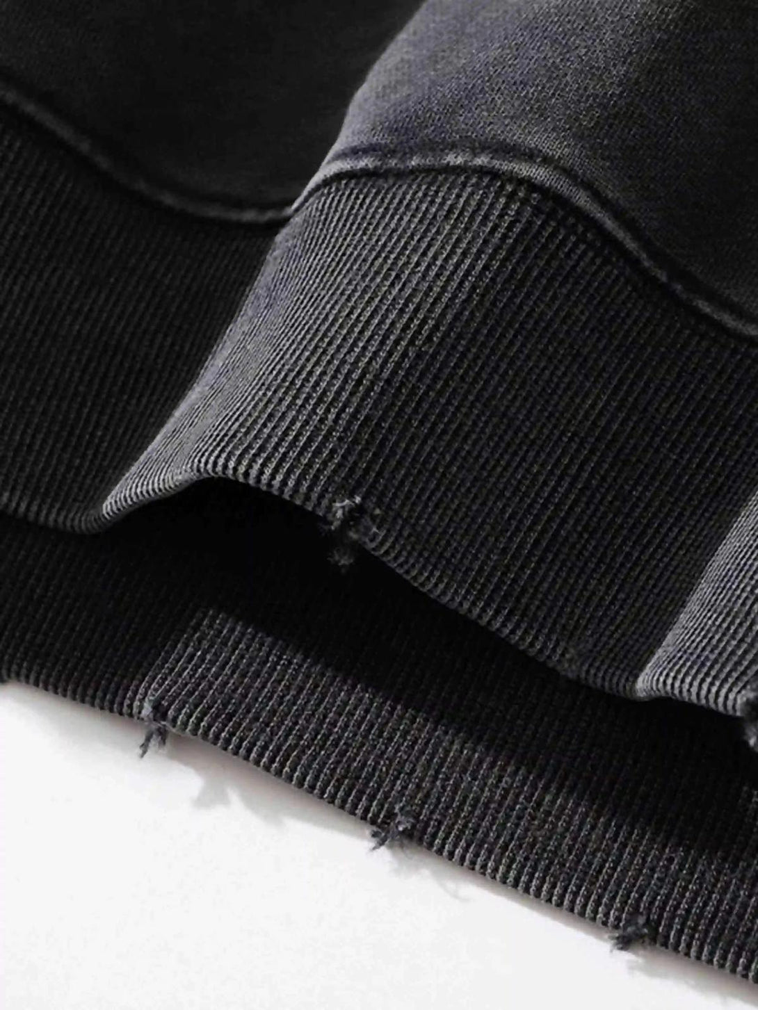 Intricate look at the distressed hem on a TALISHKO hip-hop hoodie, highlighting rugged charm.