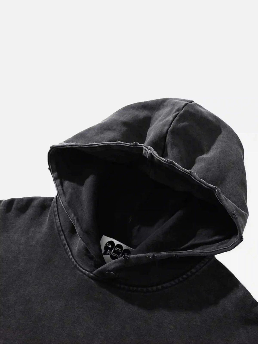 Detailed view of the hood on a worn black TALISHKO hoodie, highlighting its rugged style.