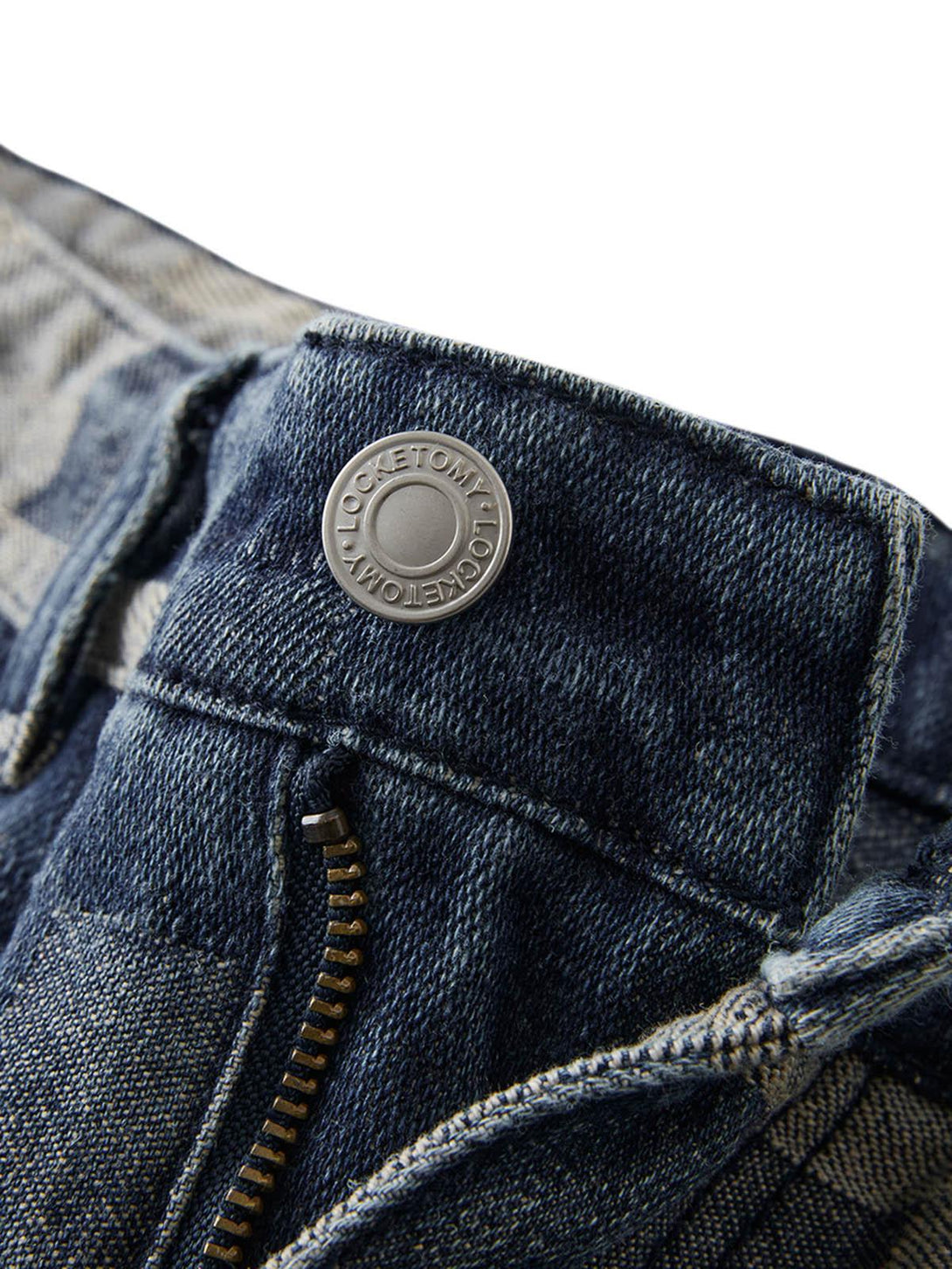 Intricate look at TALISHKO jeans button and zipper with checkerboard jacquard detail.