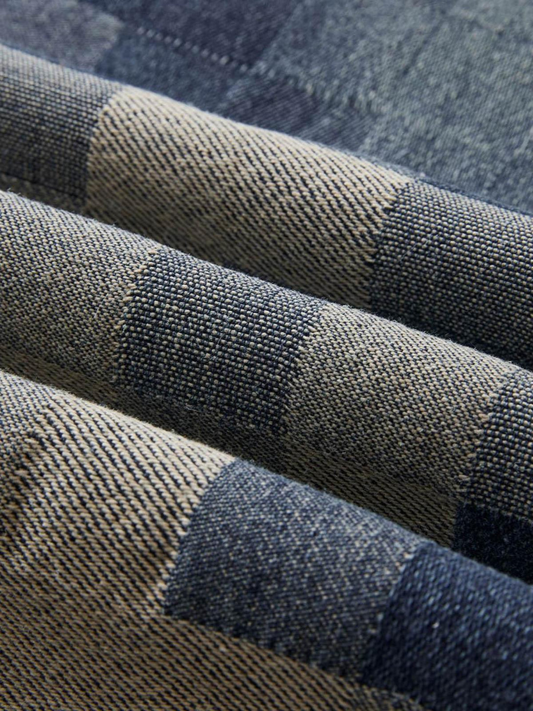 Texture and pattern showcased in TALISHKO checkerboard jacquard wide-leg jeans fabric.