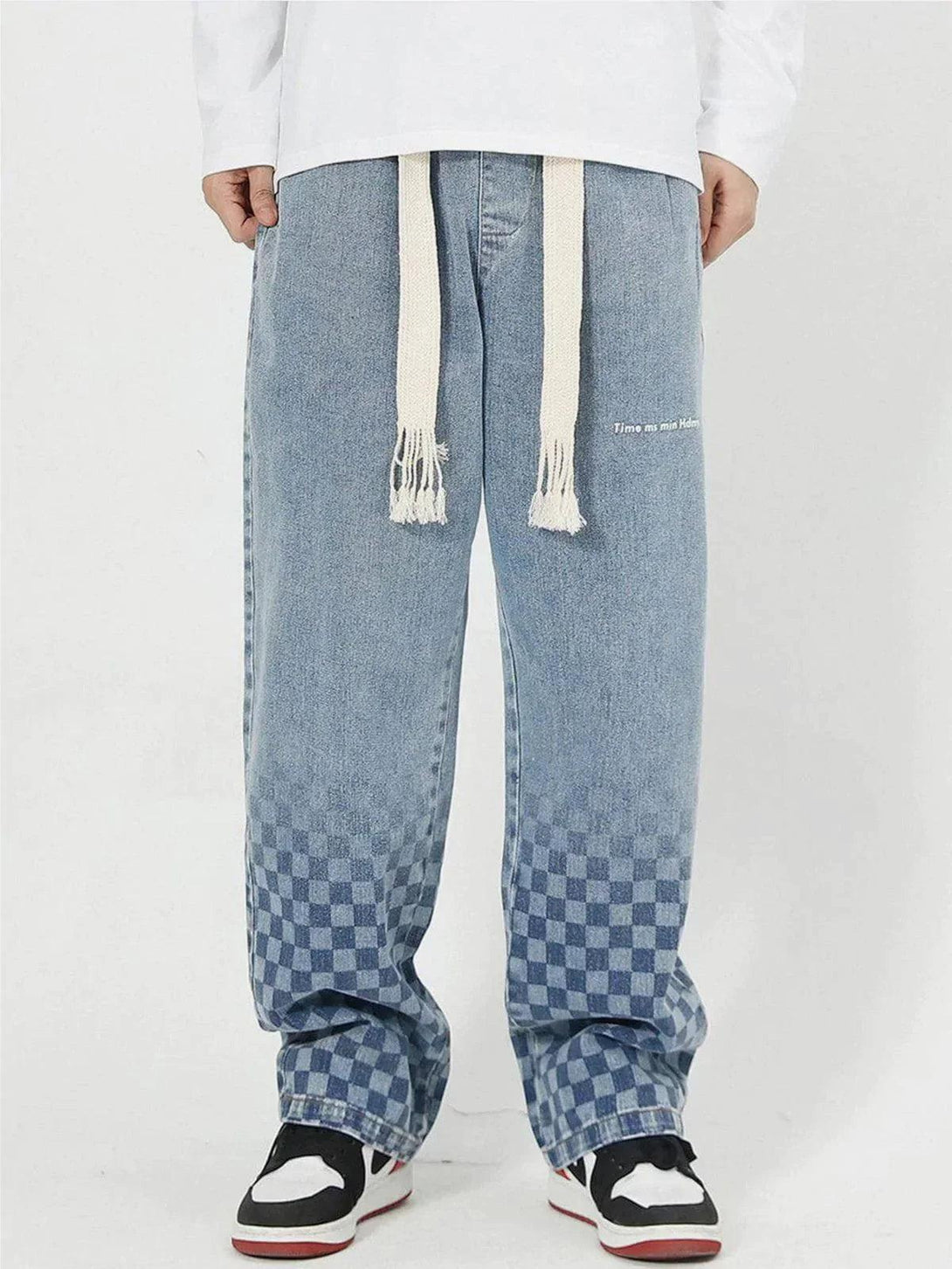 Model wearing TALISHKO checkerboard print jeans with a casual, relaxed fit.