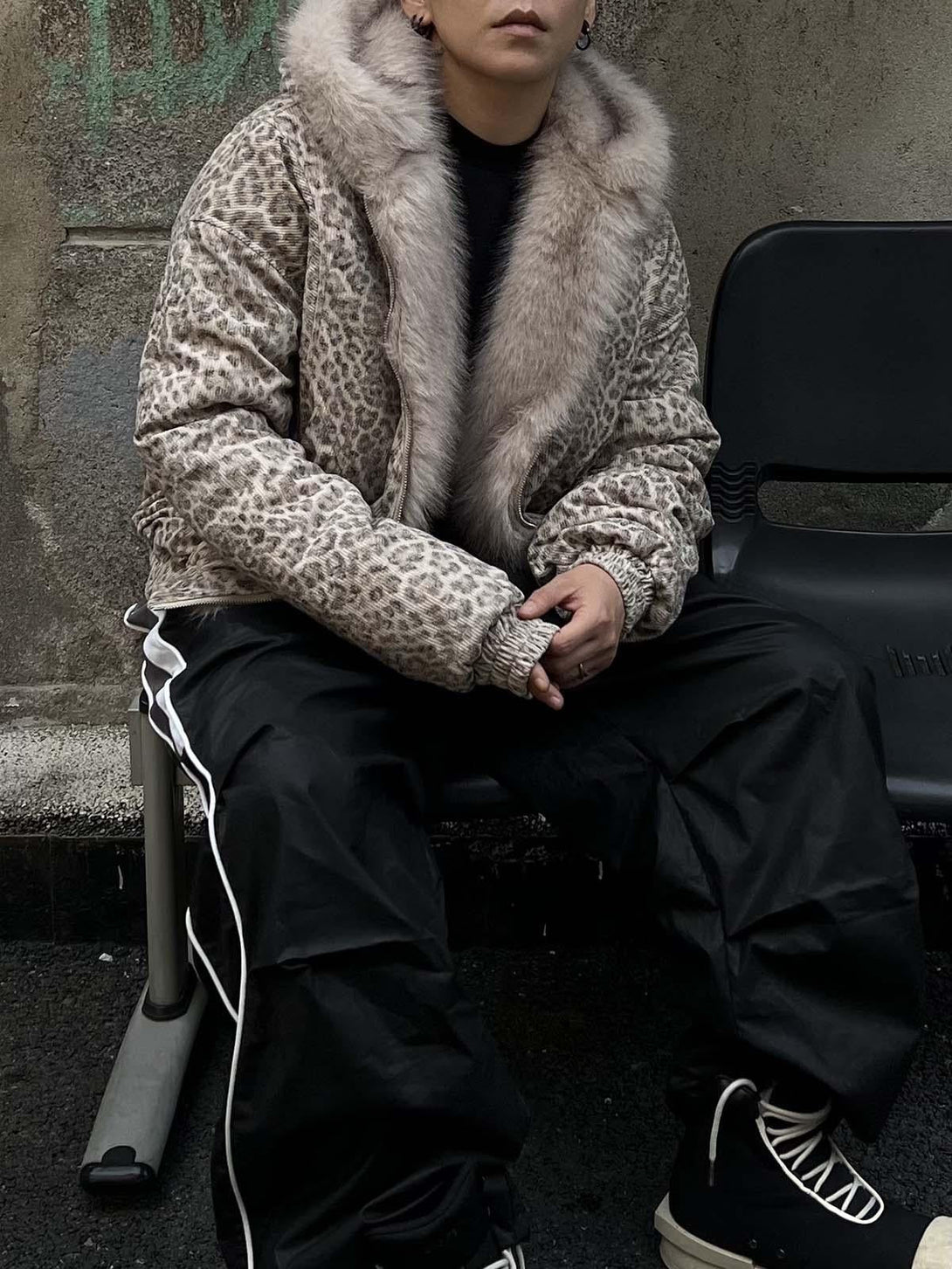 A model wearing a cheetah print jacket with a mink fur hood, styled by TALISHKO.