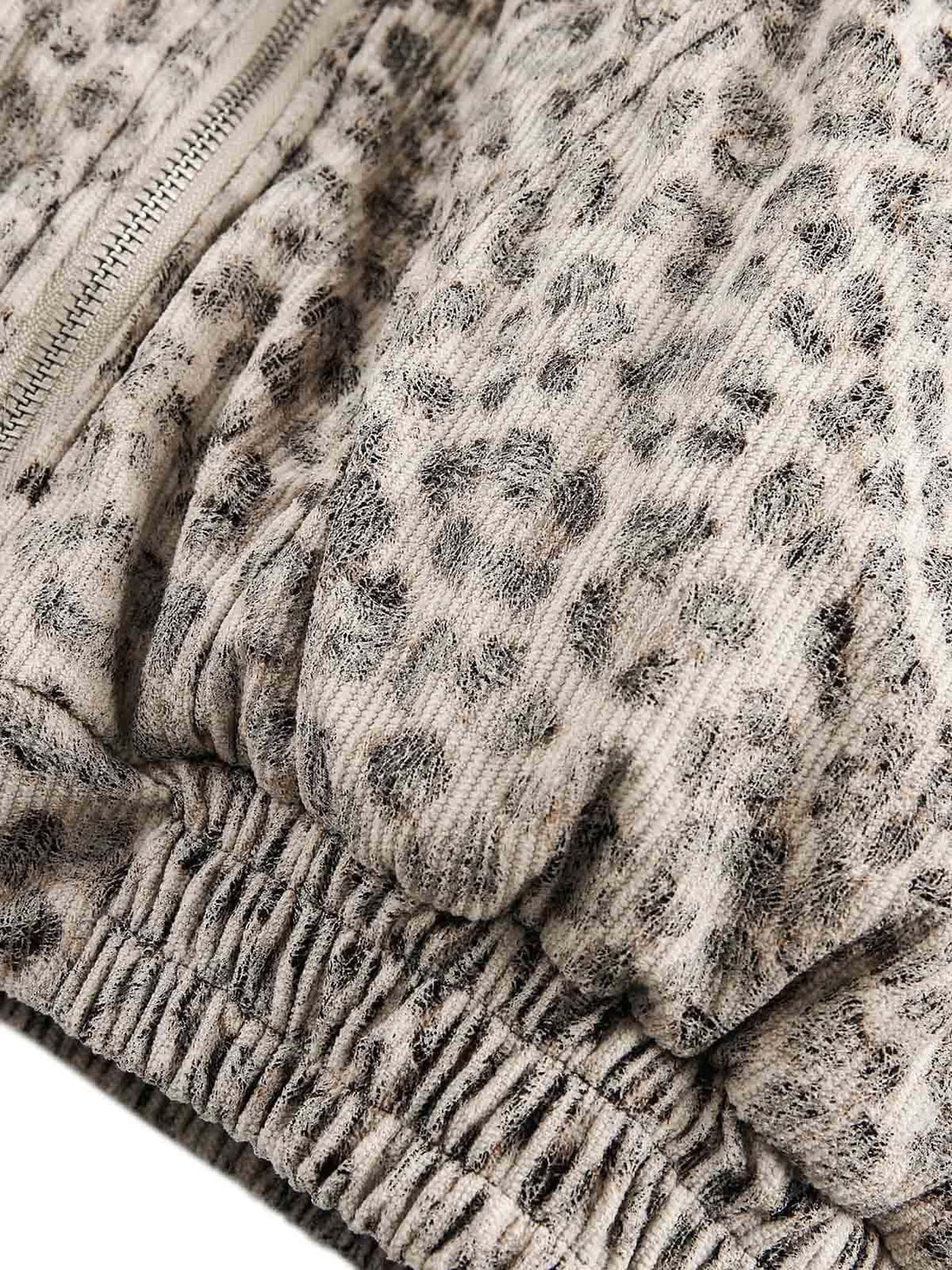 TALISHKO jacket showcasing intricate cheetah print fabric and gathered elastic details.