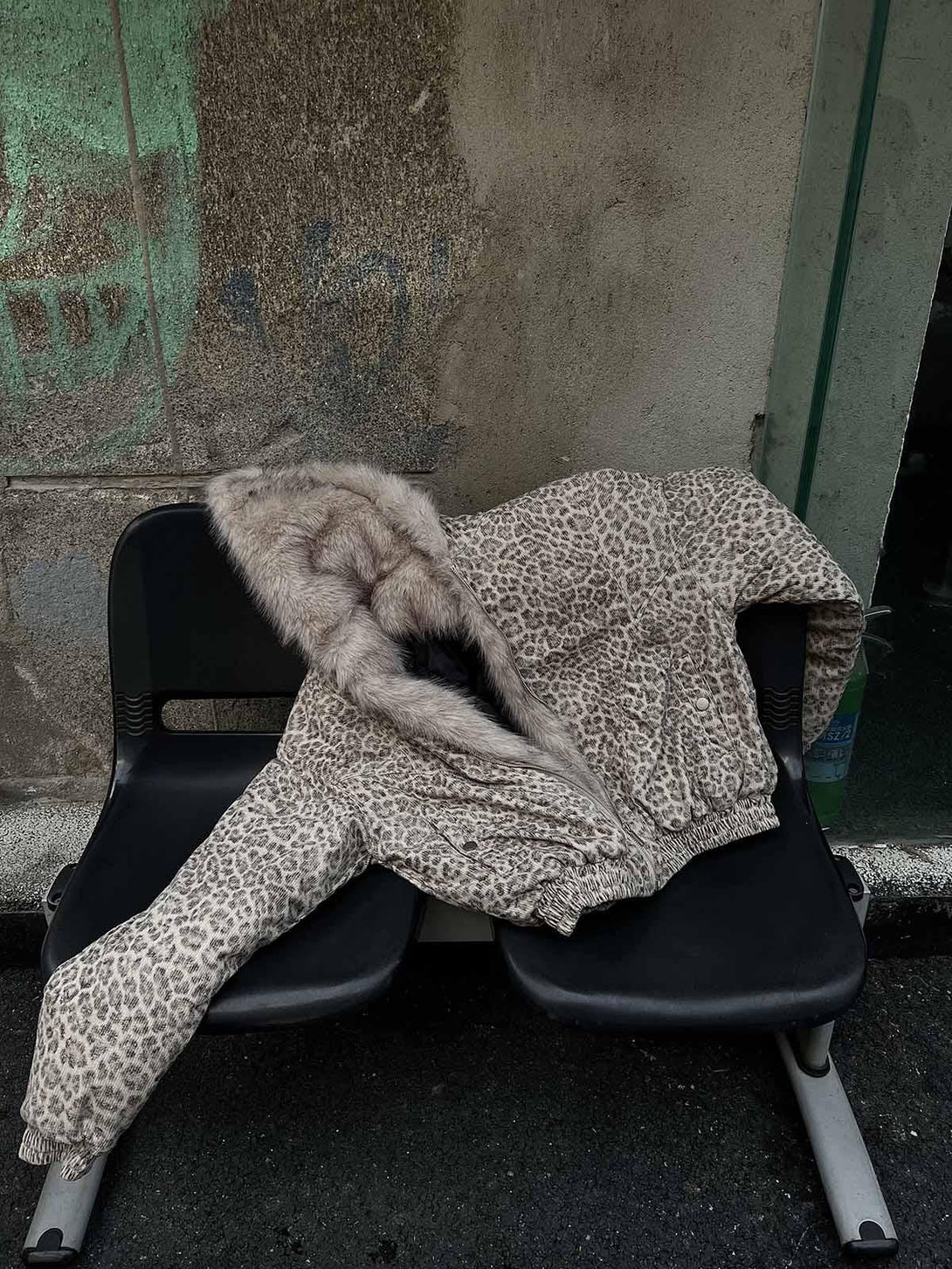 A detailed look at the TALISHKO cheetah print jacket with a luxurious mink fur hood.