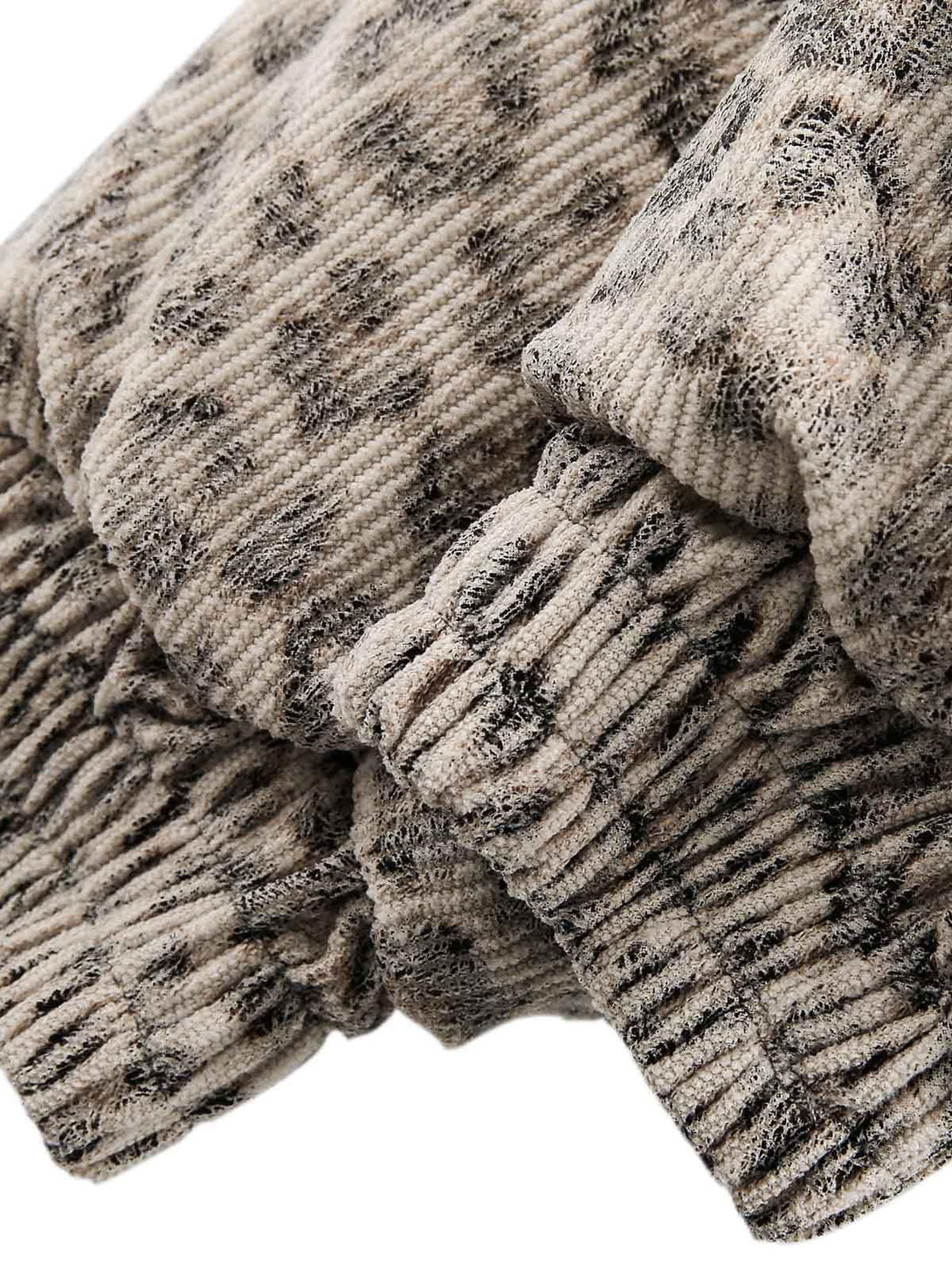 TALISHKO jacket highlighting the textured cheetah print fabric and gathered cuff details.