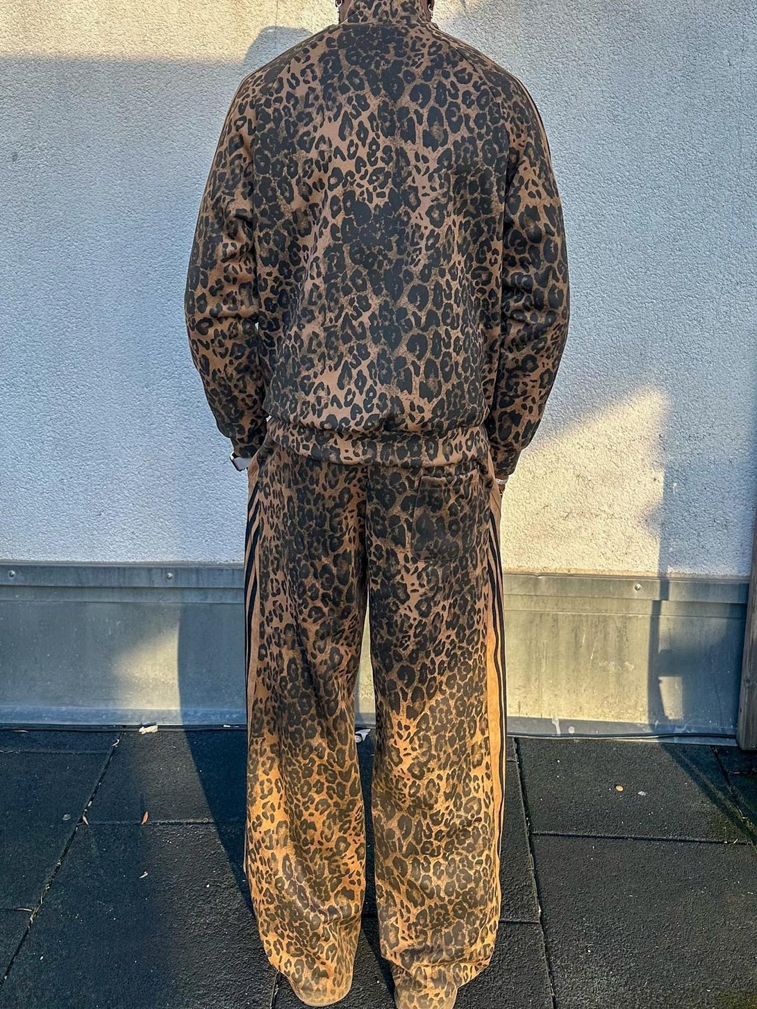 Back view of TALISHKO cheetah print tracksuit, showcasing suede texture and relaxed style.
