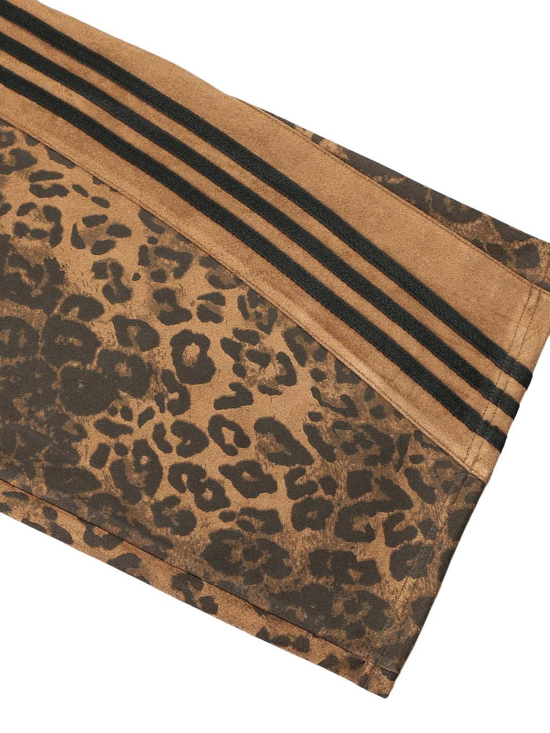 Zoomed-in texture of TALISHKO cheetah print suede pants with bold stripes and intricate pattern.