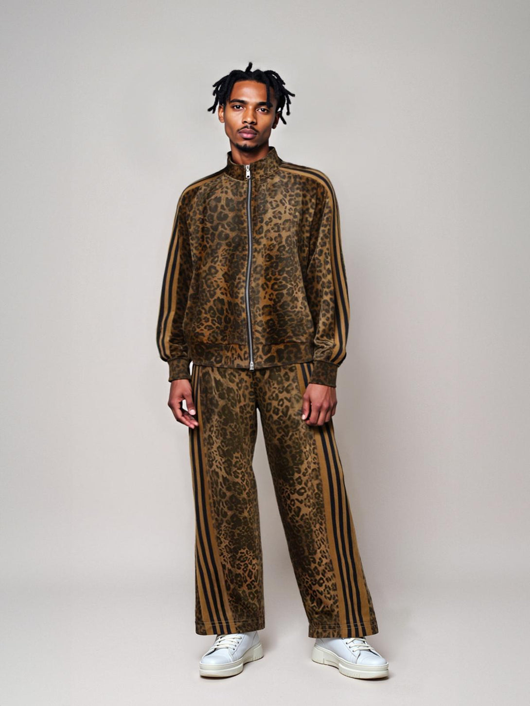 Model wearing TALISHKO cheetah print tracksuit with suede texture and bold stripes.
