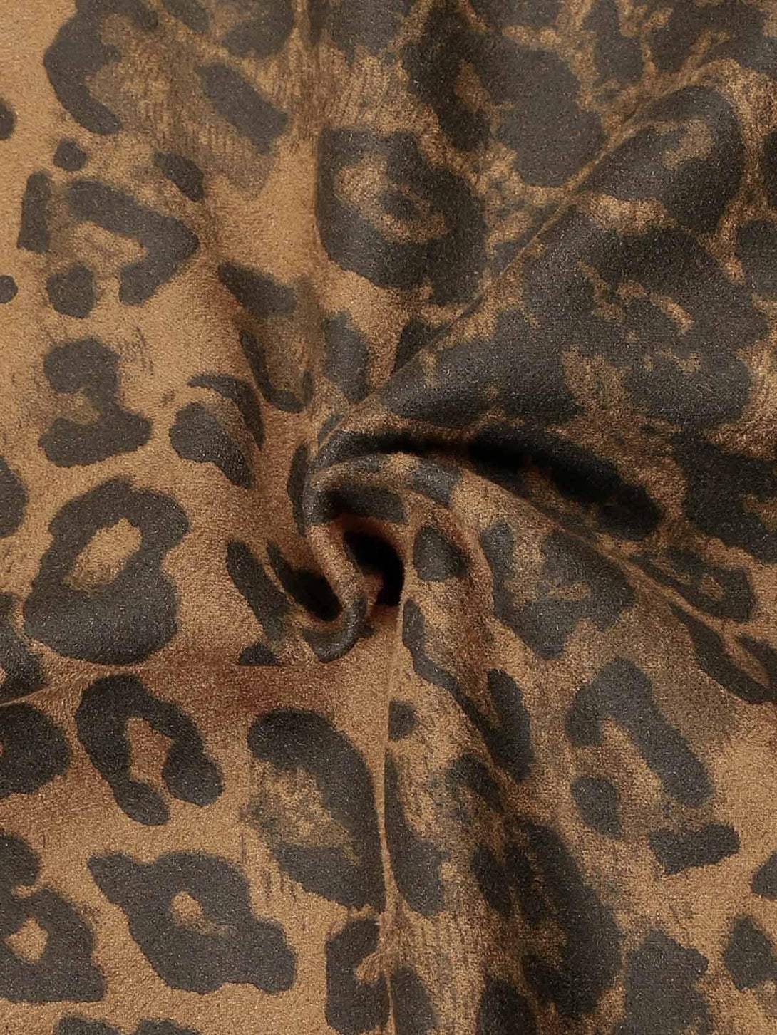 Texture and pattern showcased in TALISHKO cheetah print suede pants, highlighting intricate design.