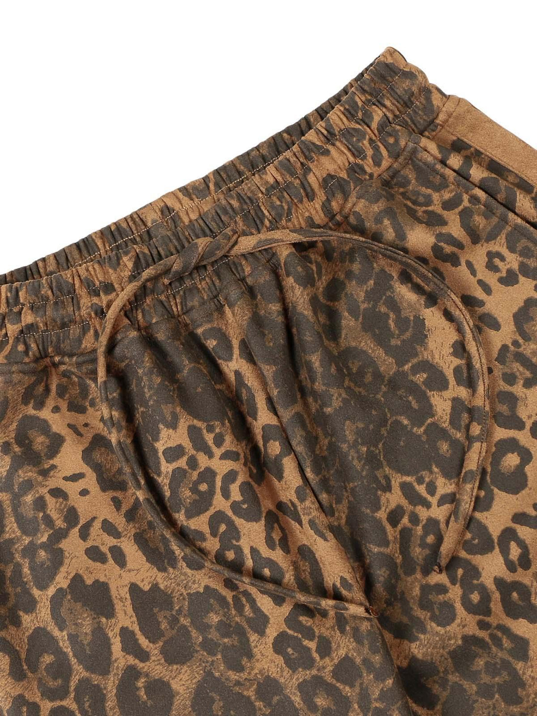 Intricate look at TALISHKO cheetah print suede pants, featuring an elastic drawstring waist.