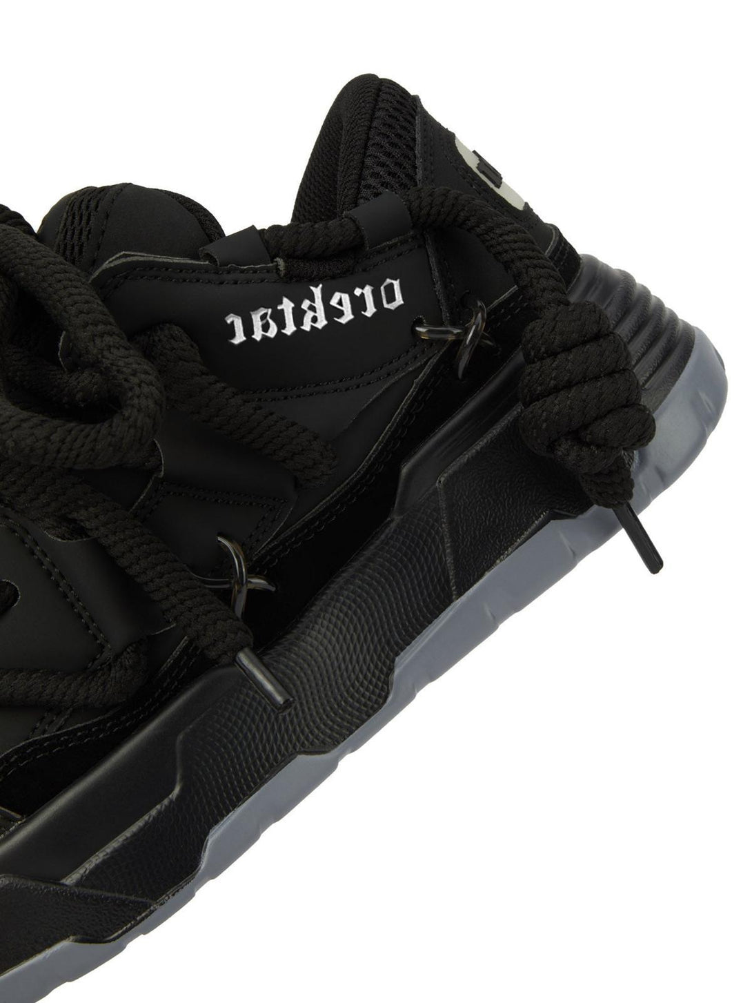 Detailed look at black chunky rope shoes by TALISHKO, highlighting bold lacing and texture.