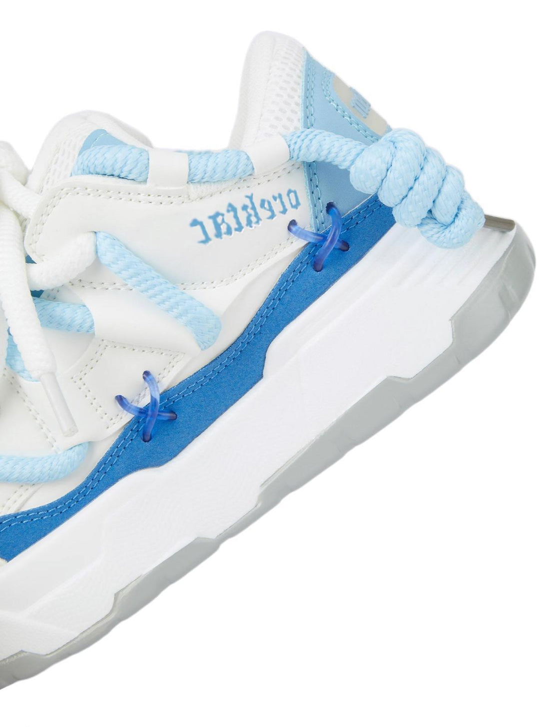 Intricate look at TALISHKO chunky rope shoes in blue and white, focusing on unique lace design.