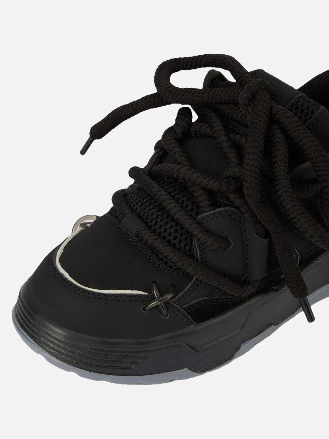 Intricate look at black chunky rope shoes by TALISHKO, focusing on unique lace details.