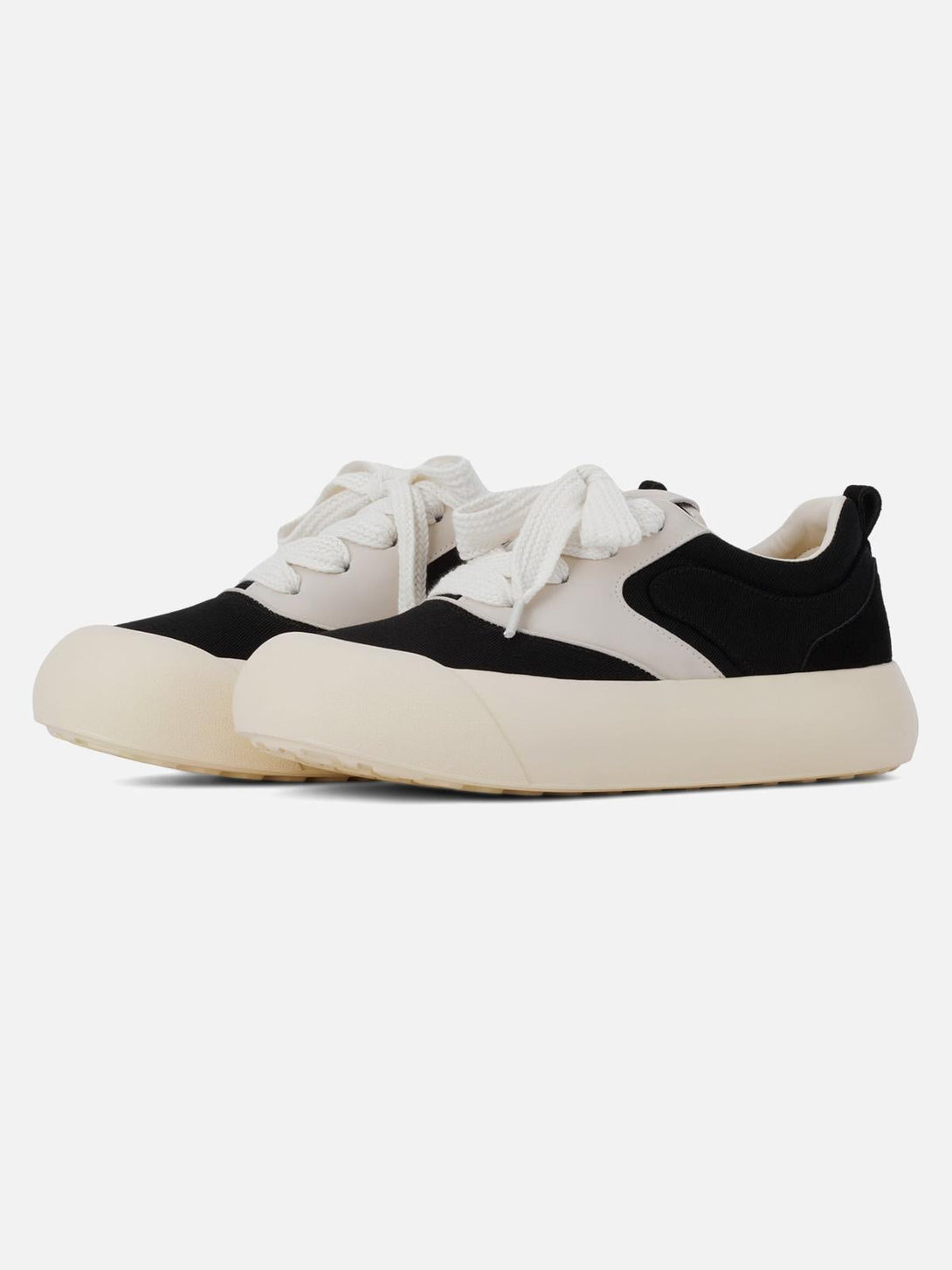 Chunky round-toe color-block sneakers by TALISHKO, featuring a stylish black and cream design.