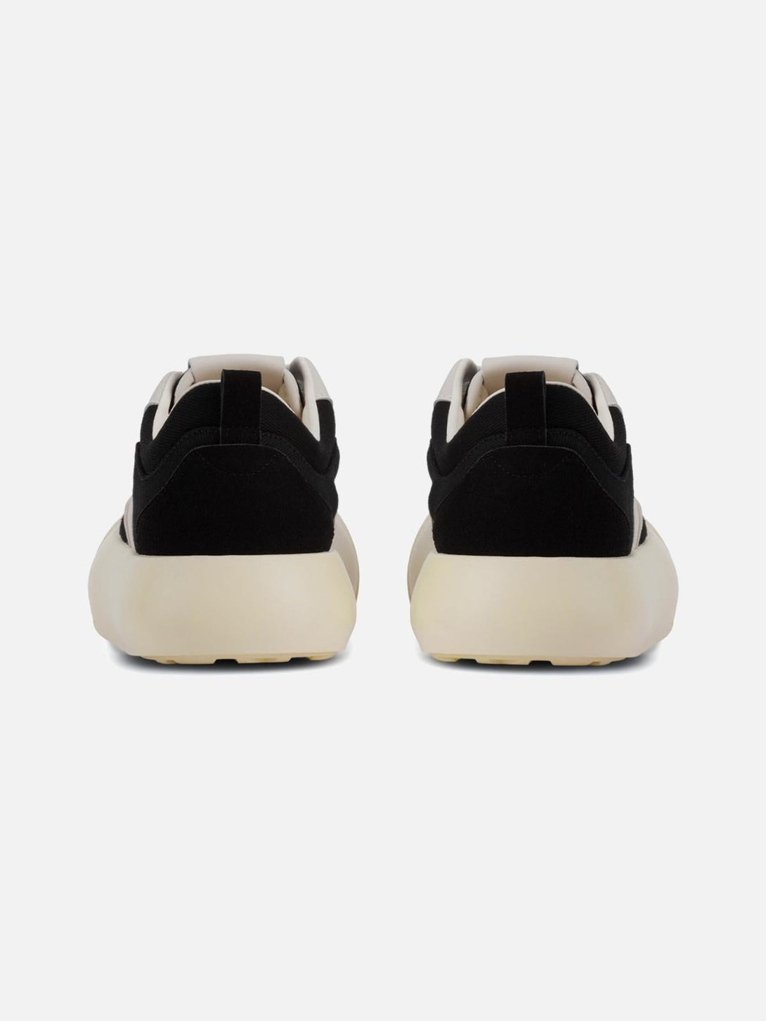 Back view of TALISHKO's color-block sneakers highlighting the chunky design in black and cream.