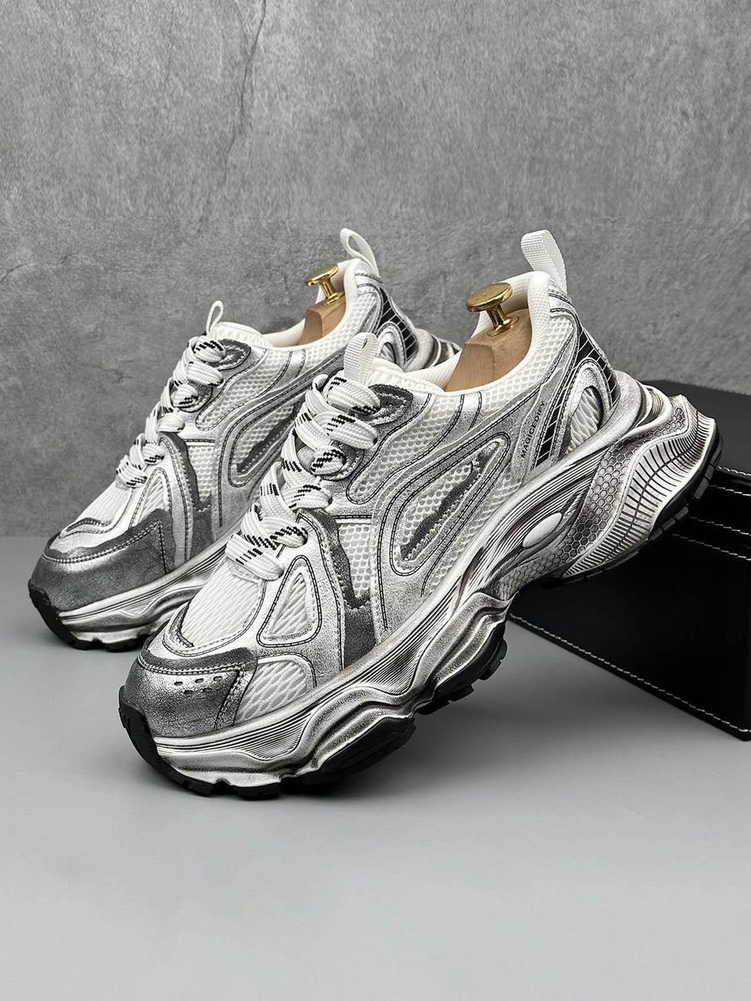 TALISHKO chunky sole sneakers in metallic, side view showcasing dynamic design and texture.