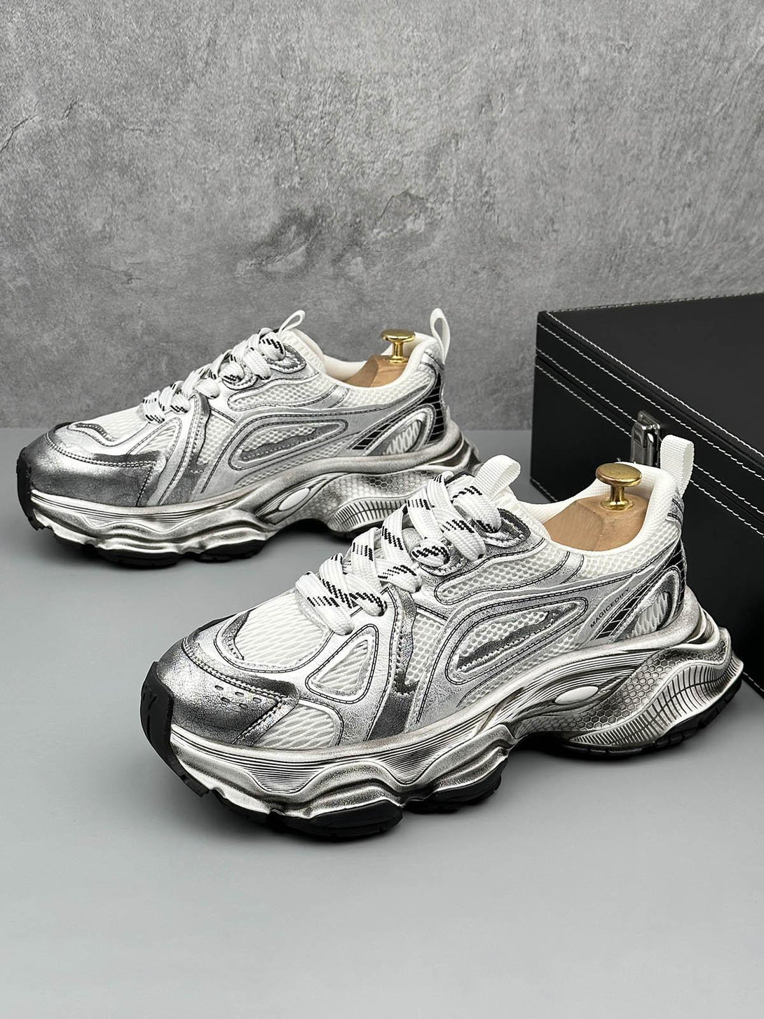 TALISHKO chunky sole sneakers with a metallic finish, side view highlighting intricate design.