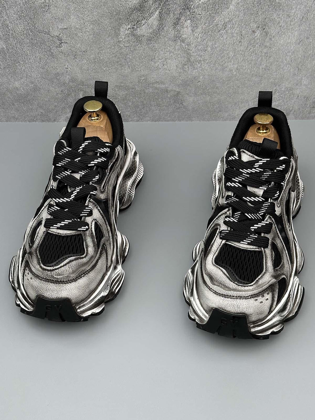 TALISHKO chunky sole sneakers in metallic, front view showcasing unique design and texture.