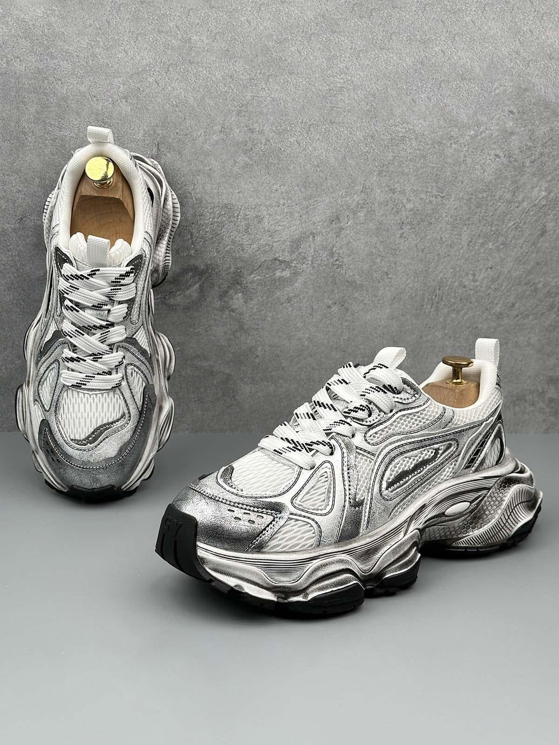 TALISHKO chunky sole sneakers in metallic, front view highlighting bold, intricate design.