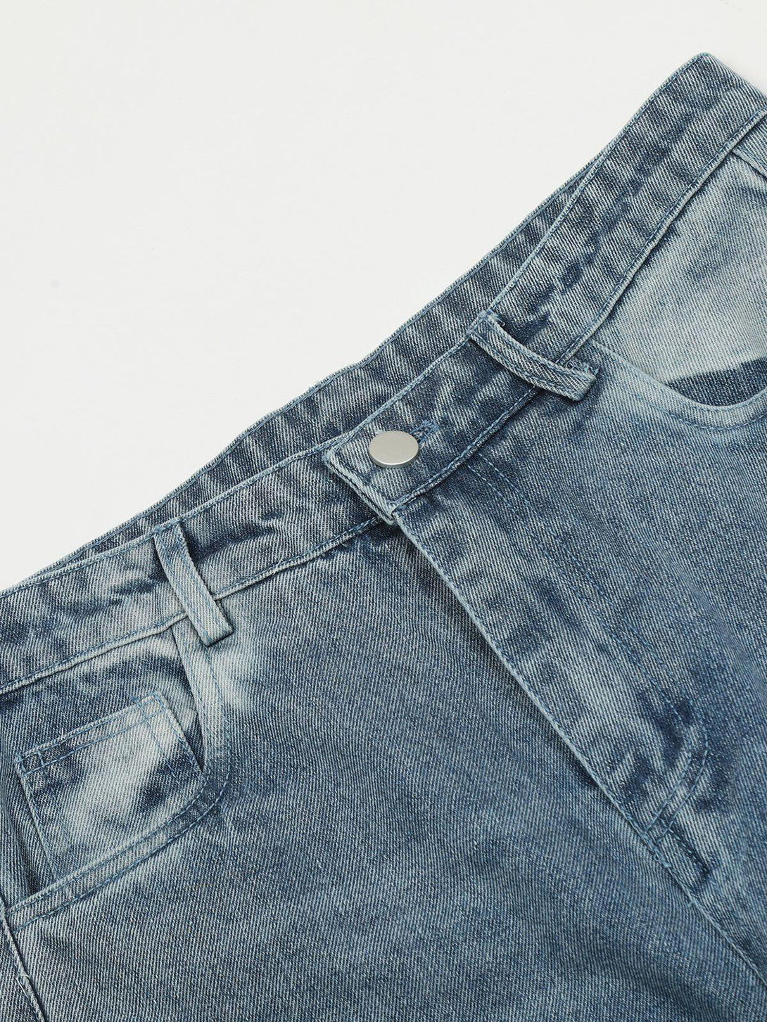 Focusing on TALISHKO's circle cut-out jeans, highlighting the detailed stitching and denim texture.