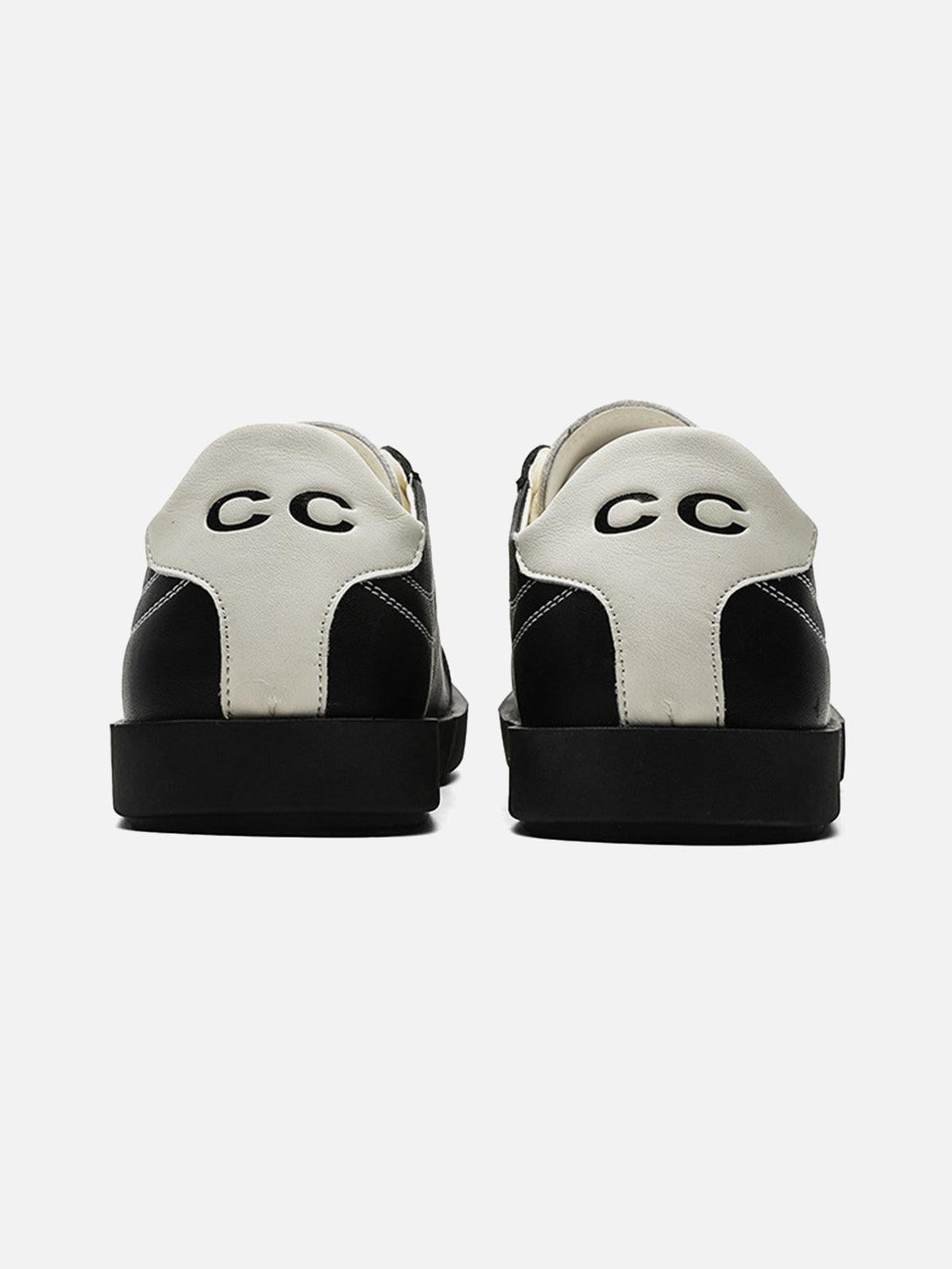 Back view of TALISHKO's black leather sneakers, featuring bold white heel accents.