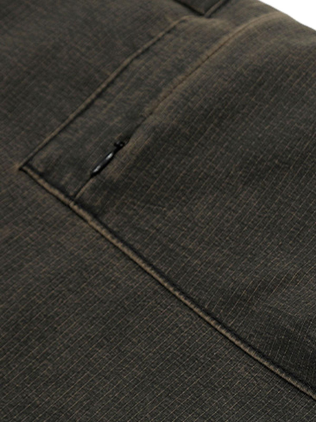 Detailed fabric and stitching of TALISHKO's classic cargo pants in a dark hue.