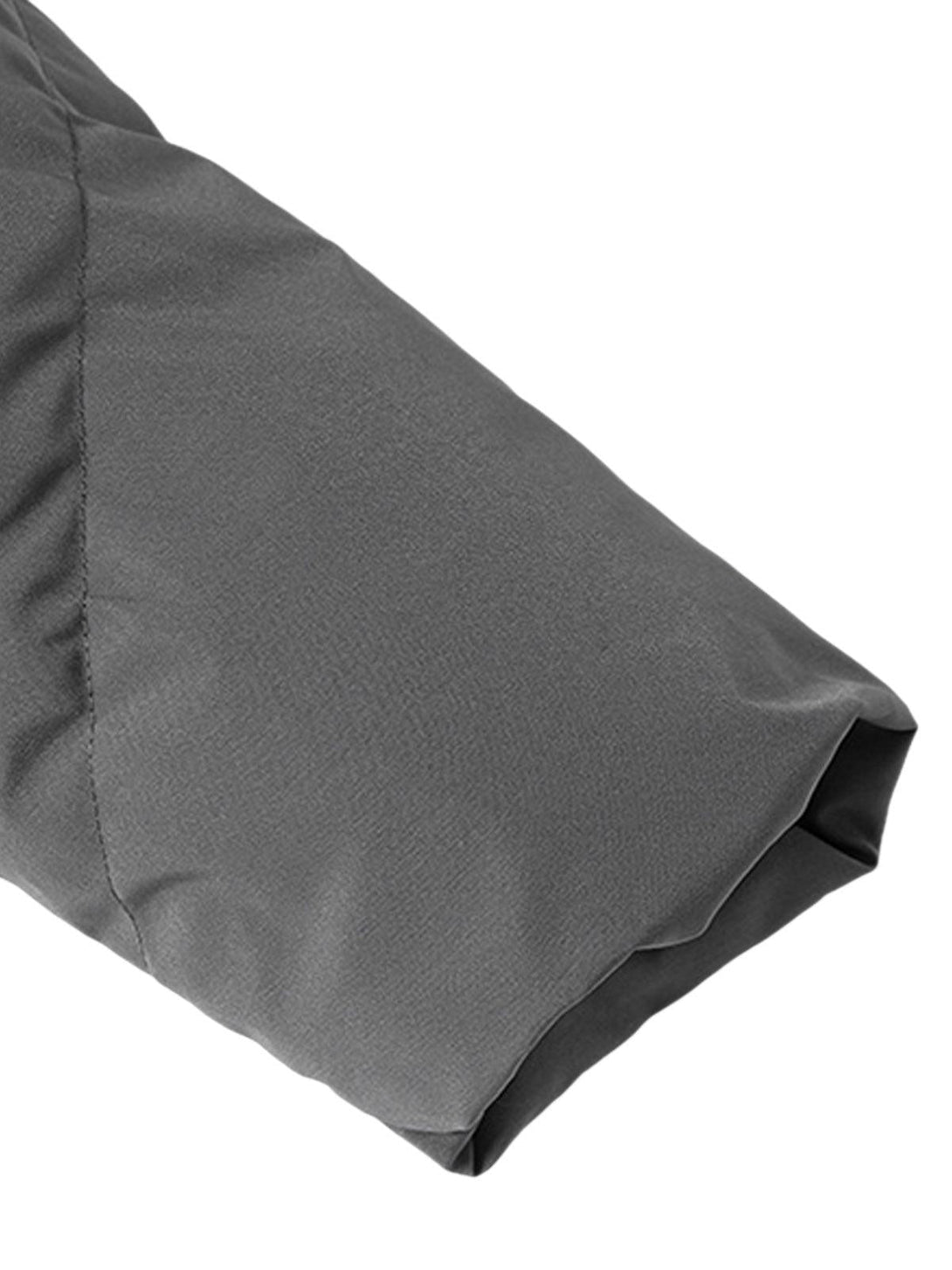 Focusing on the sleeve detail of a gray puffer jacket by TALISHKO, highlighting its texture.