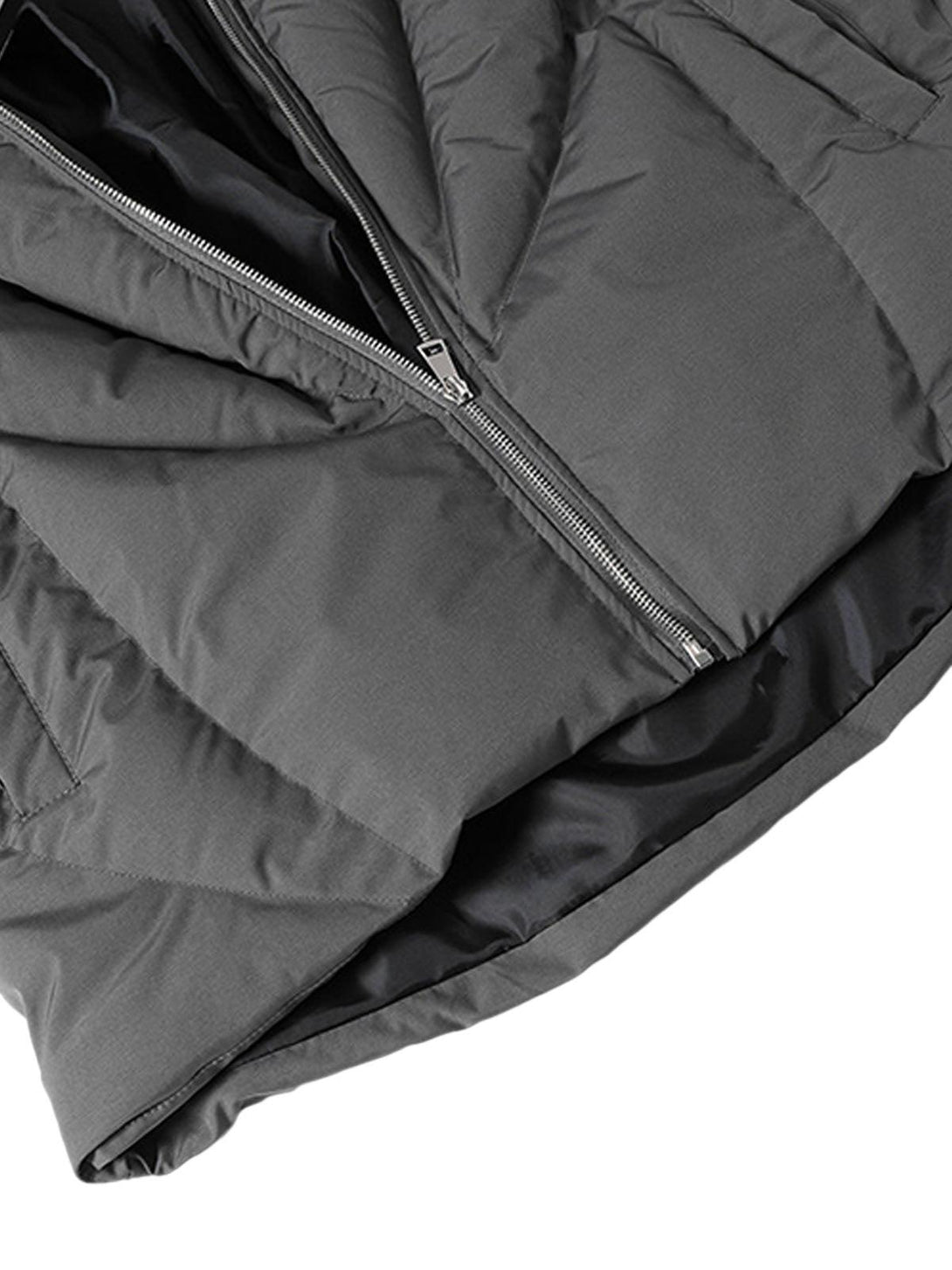 A detailed look at the gray puffer jacket's zipper and fabric by TALISHKO, emphasizing texture.