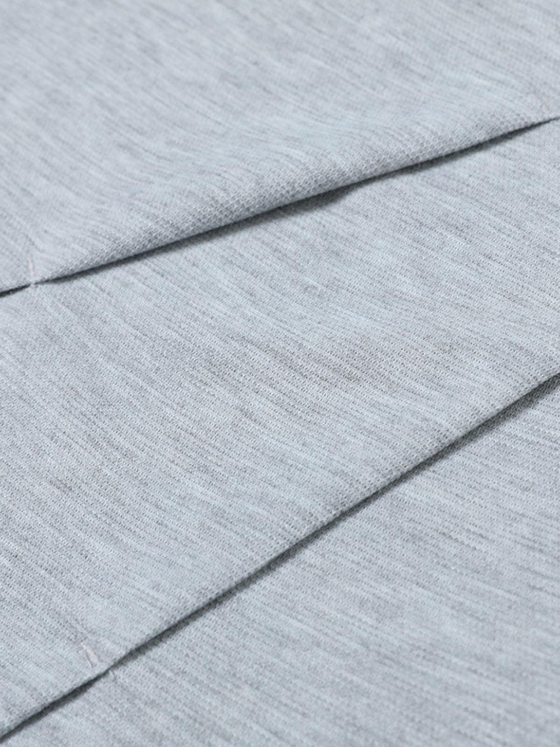Detailed fabric and stitching of a gray pleated T-shirt by TALISHKO, showcasing classic tailoring.