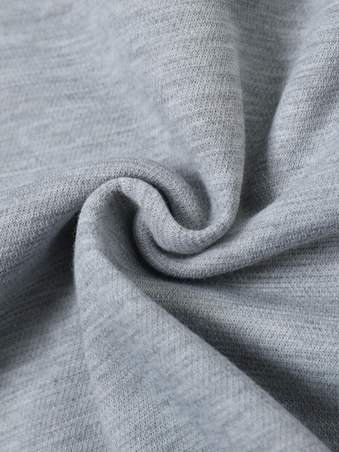 Texture and pattern showcased in a gray pleated T-shirt by TALISHKO, highlighting its elegance.