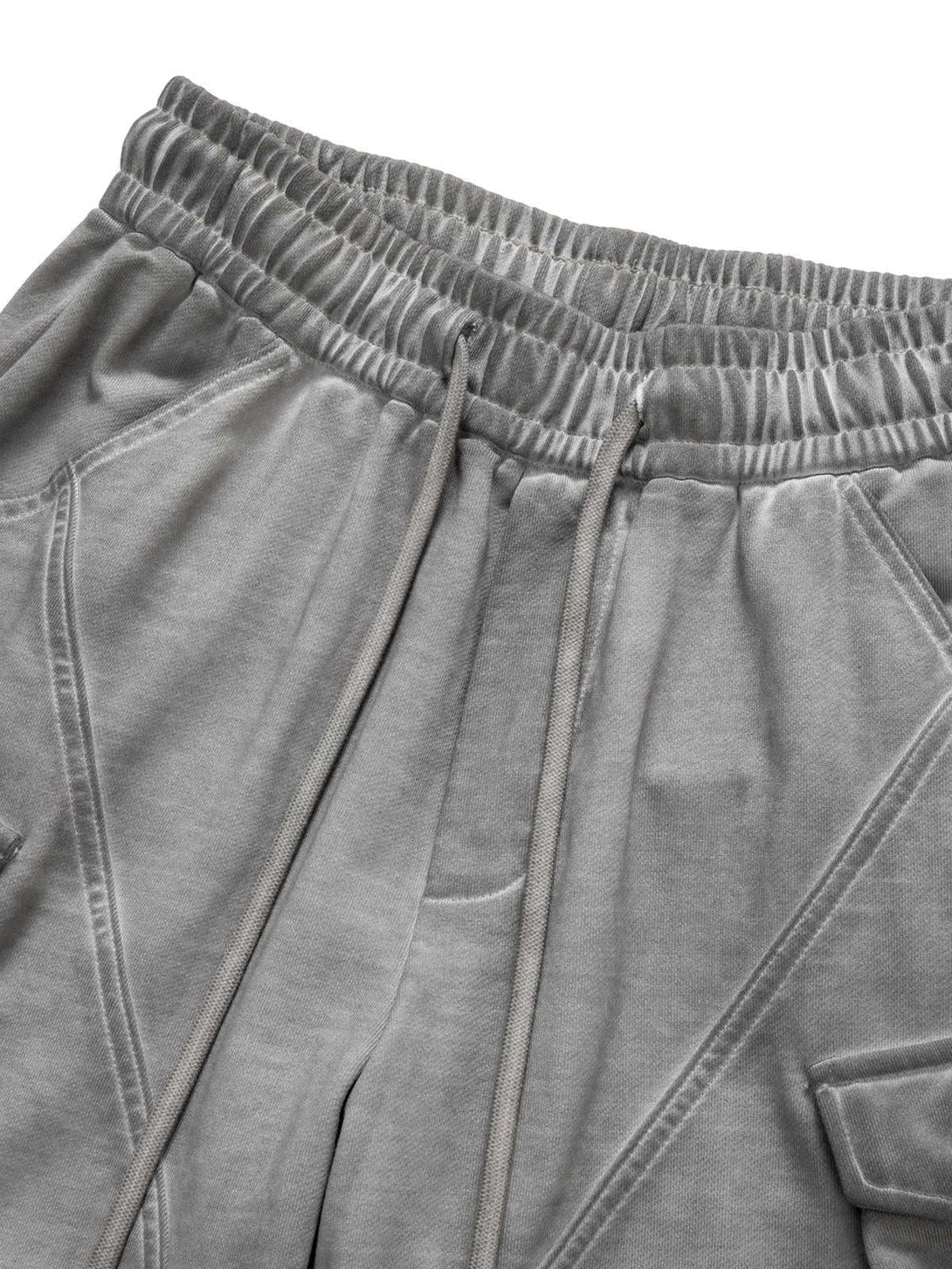 A detailed view of the velour cargo shorts by TALISHKO, featuring elastic waistband and drawstring.