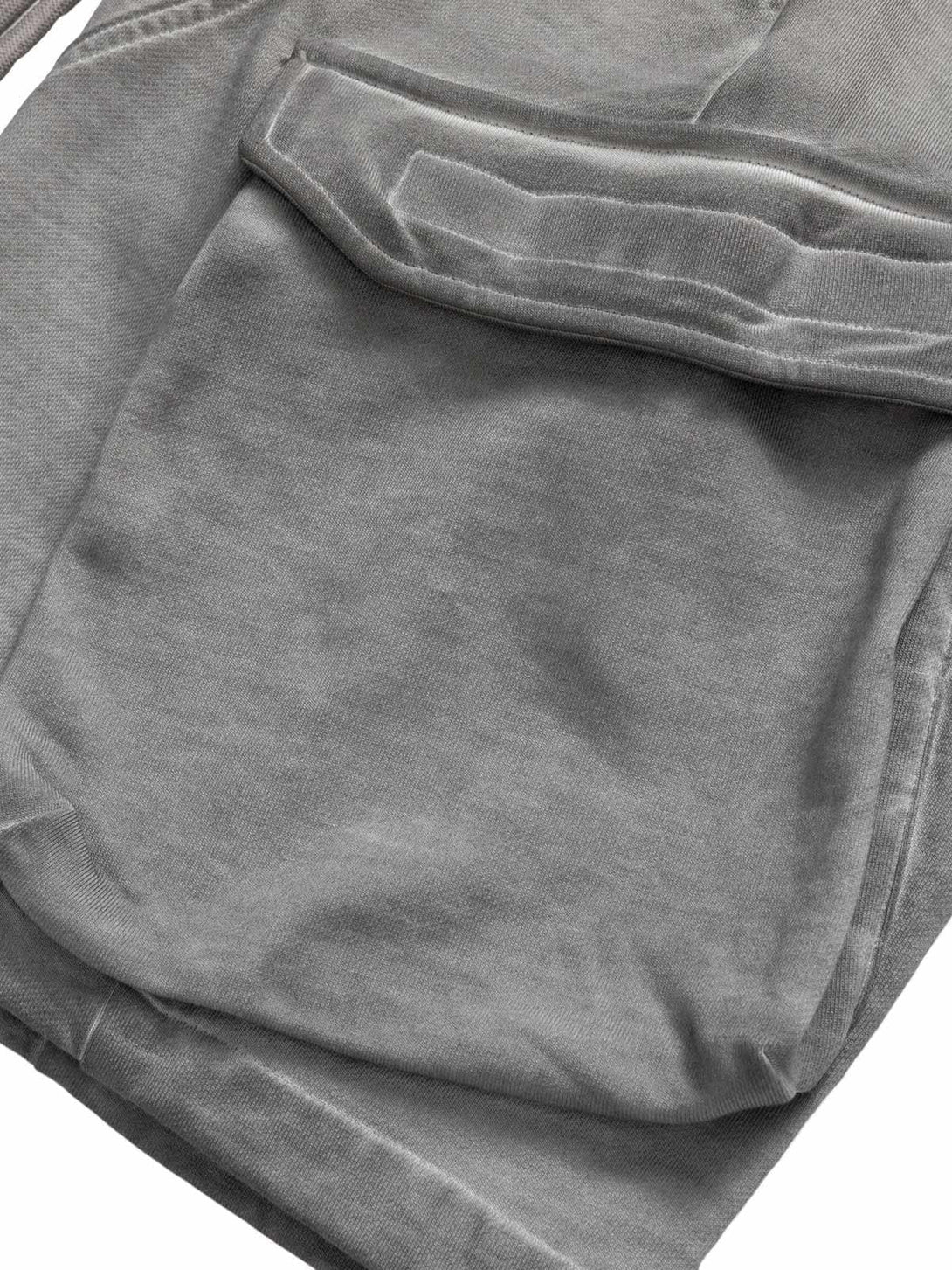 A close-up of TALISHKO's gray velour cargo shorts, highlighting the textured pocket detail.