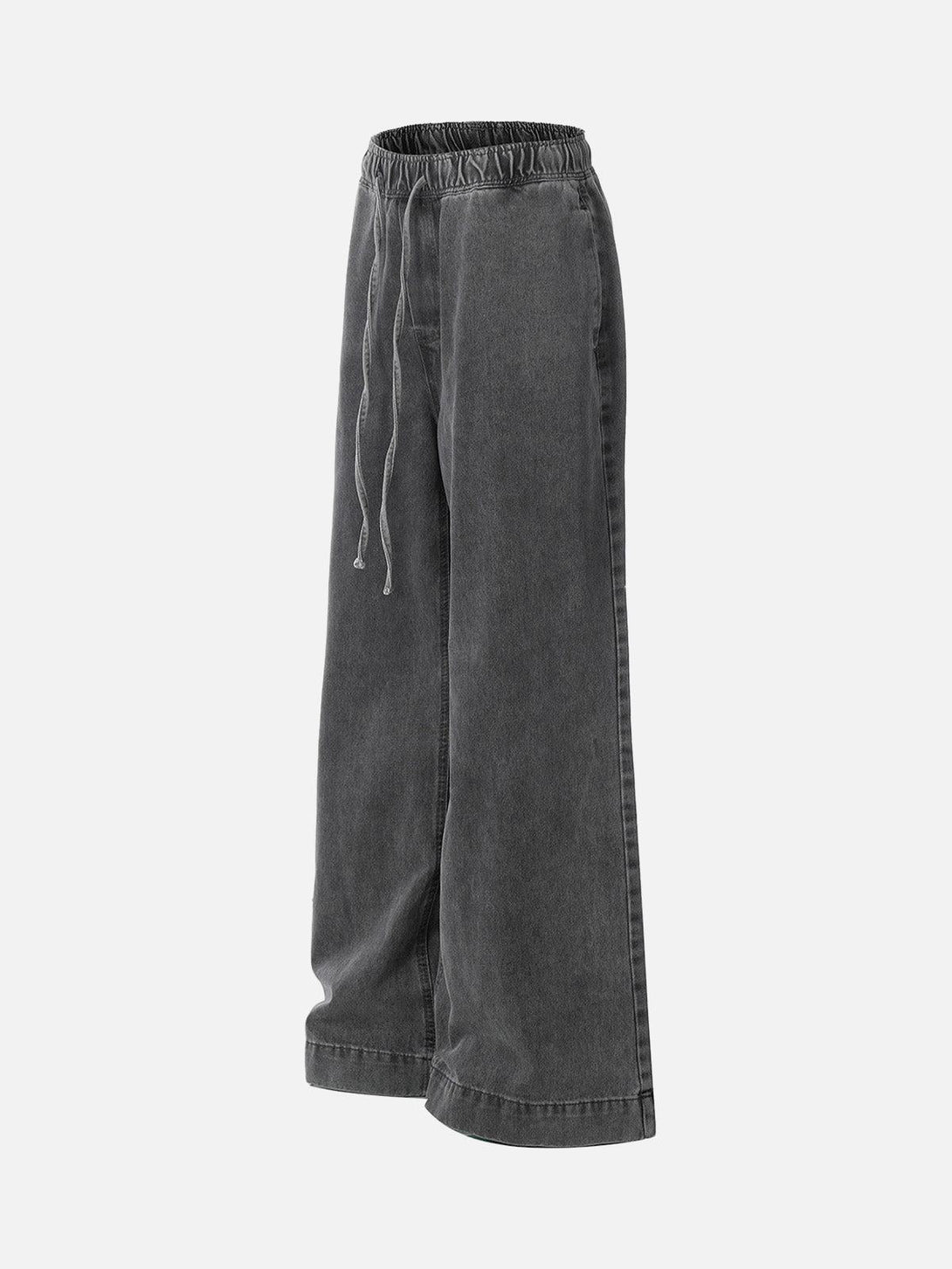 A side view of TALISHKO washed baggy jeans with a drawstring waist, showcasing relaxed style.