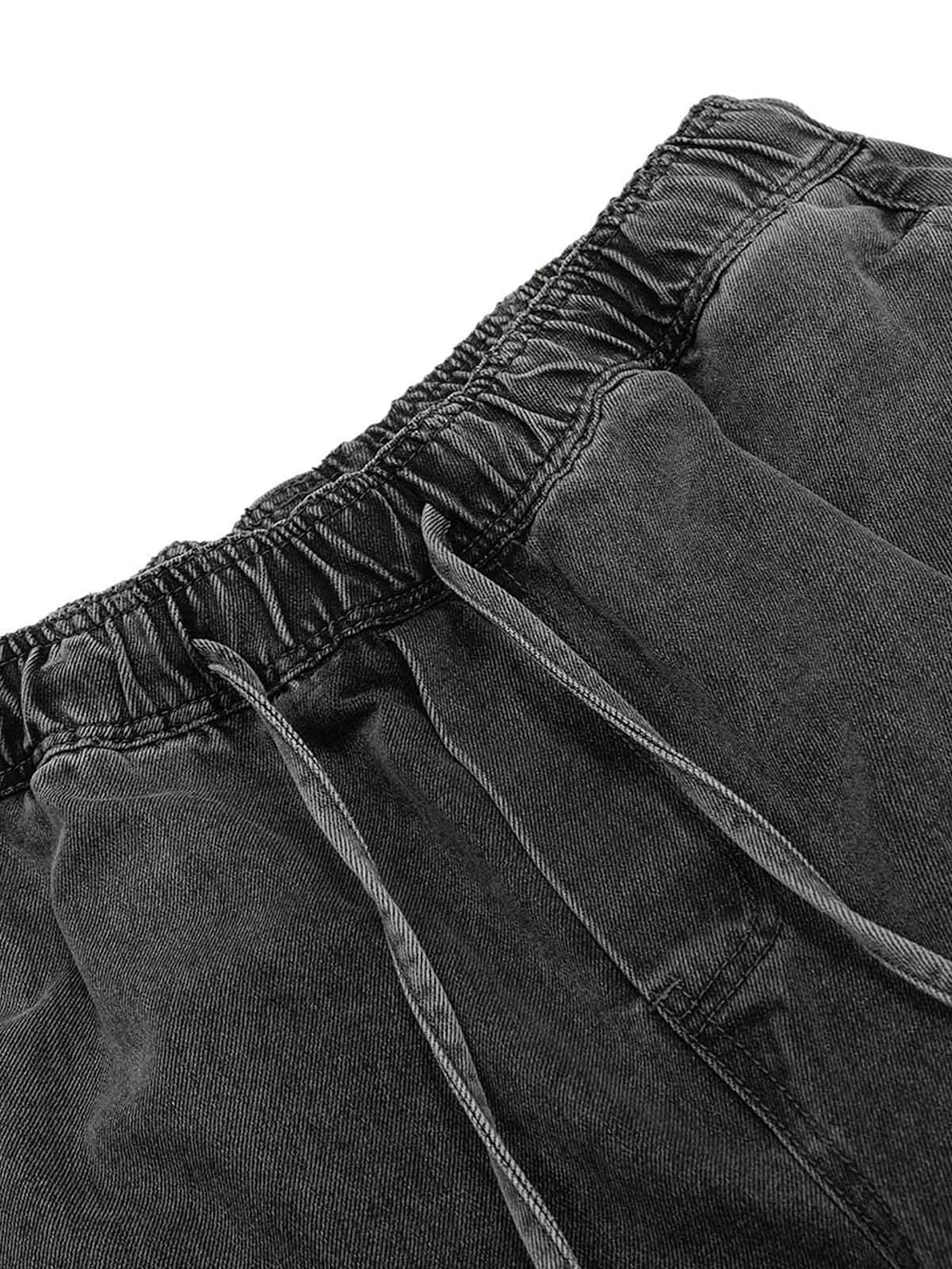 Intricate look at TALISHKO's classic washed drawstring baggy jeans highlighting the waistband detail.