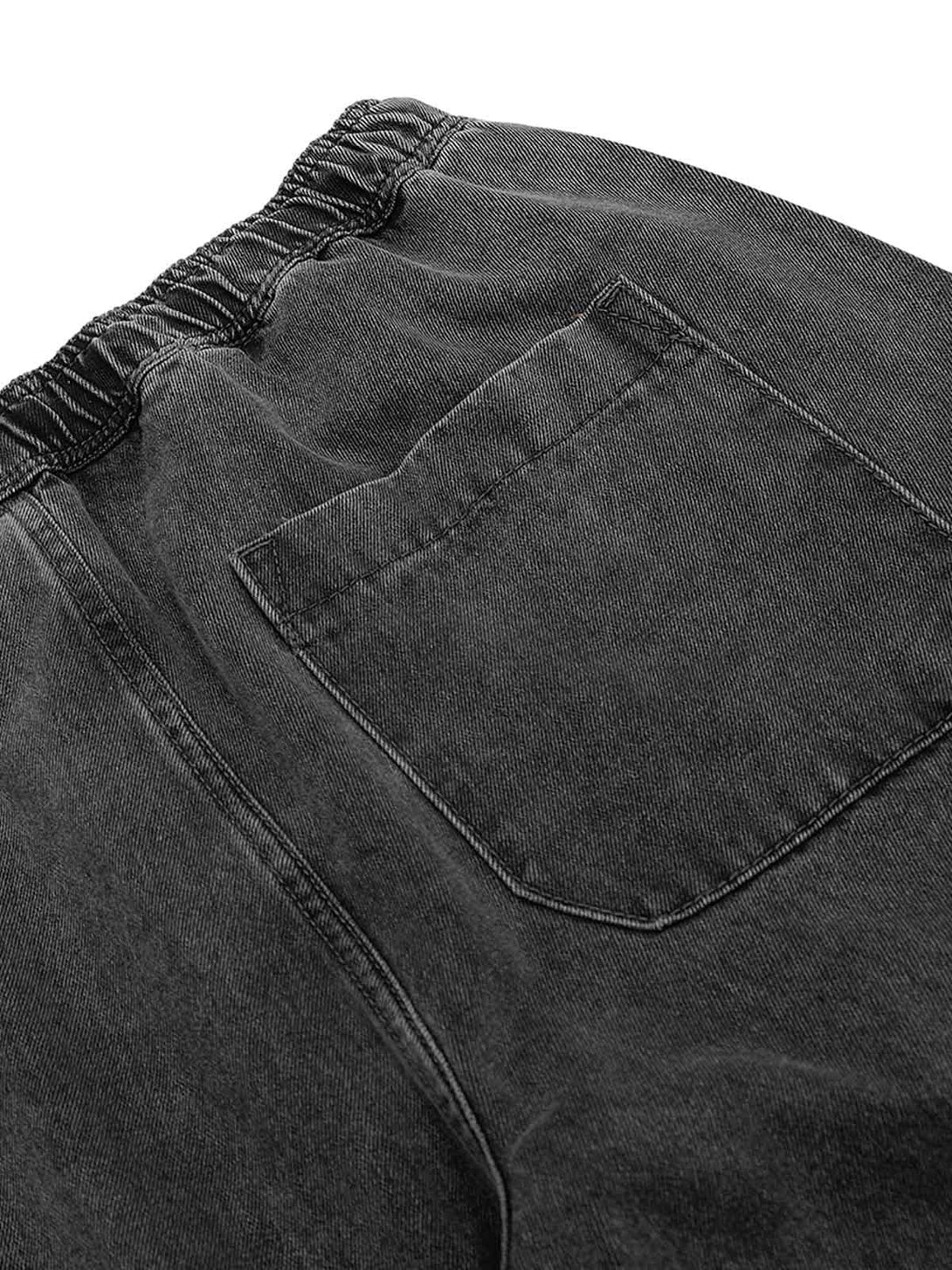 Detailed fabric view of TALISHKO's washed baggy jeans highlighting the back pocket design.