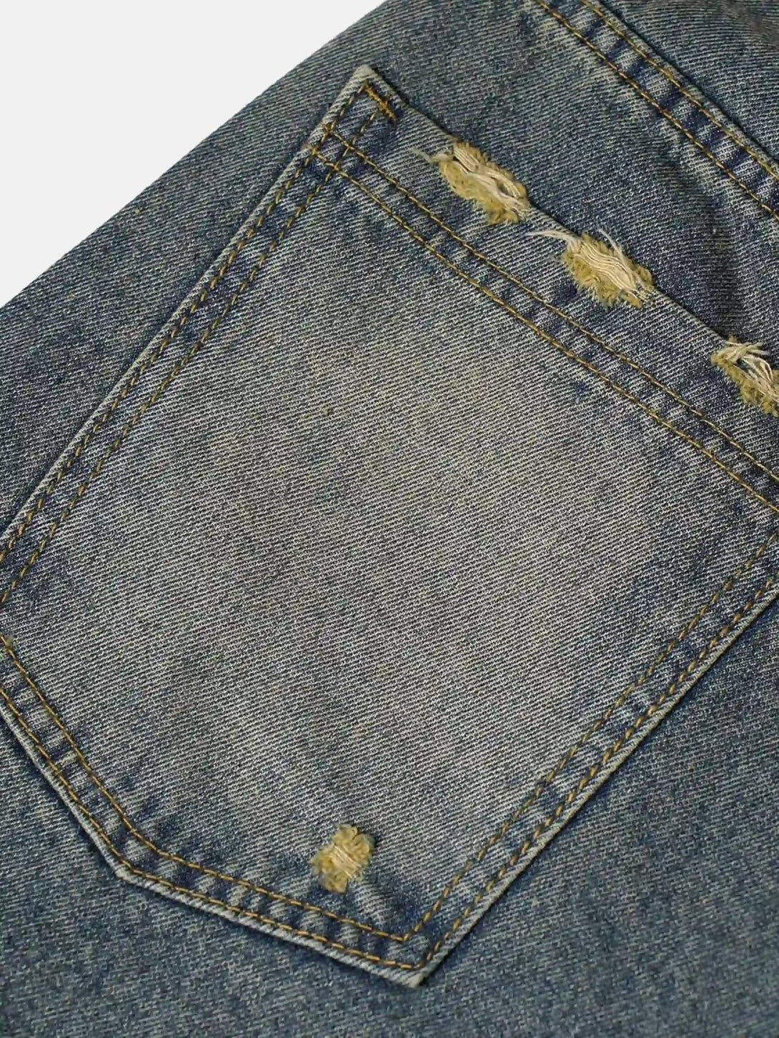 Focusing on the pocket detail of TALISHKO denim jorts, showcasing unique whisker patchwork.