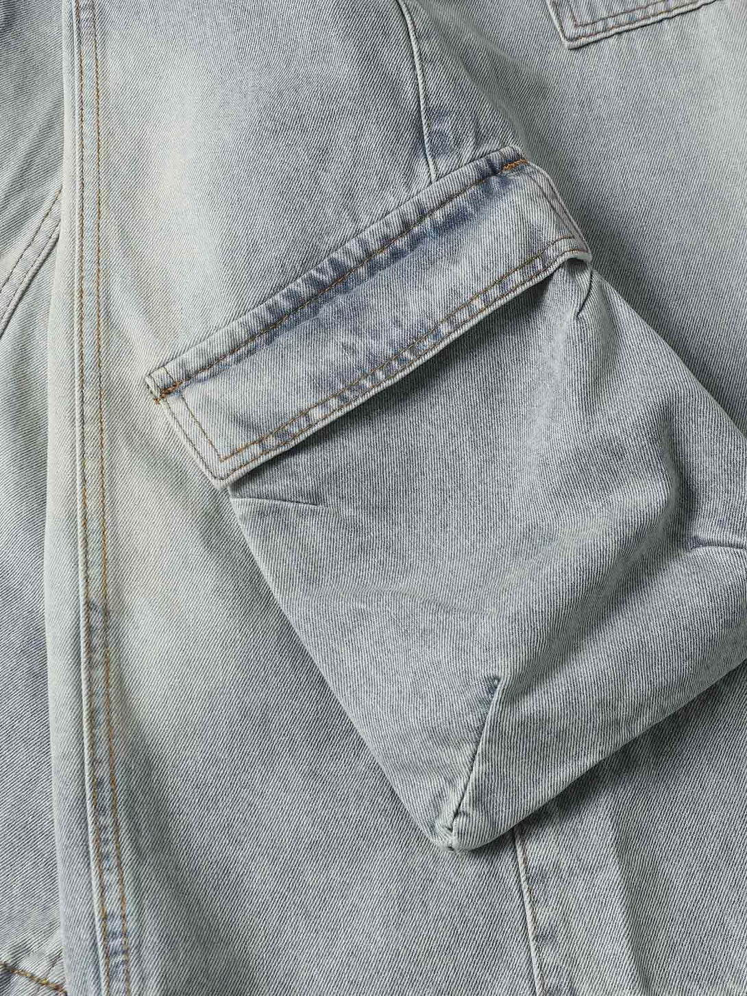 Detailed look at TALISHKO's denim cargo jorts pocket, showcasing relaxed summer style.