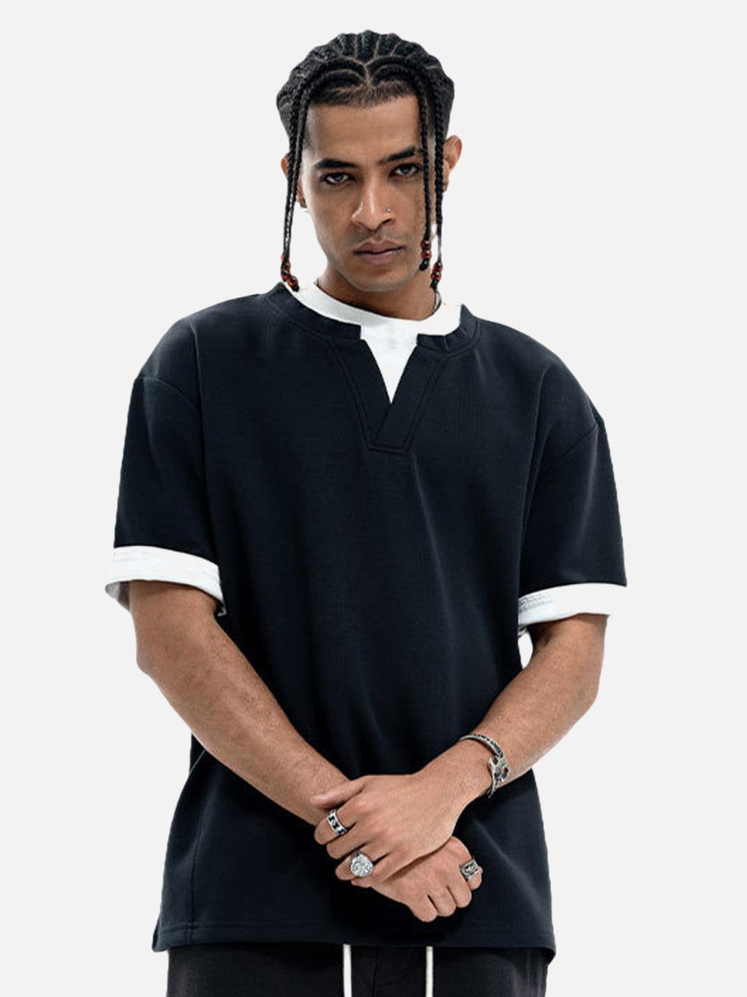 Model in a TALISHKO black oversized t-shirt with a faux layered look and casual style.