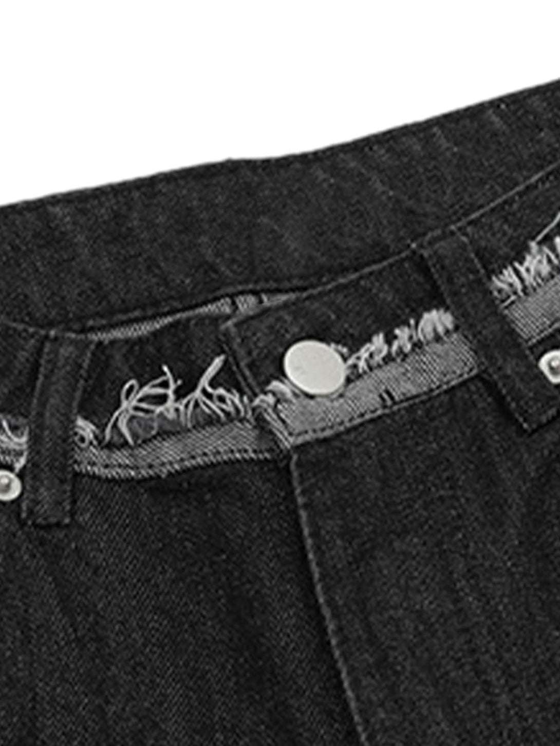Focusing on the raw edge detail of TALISHKO denim shorts, highlighting casual summer style.