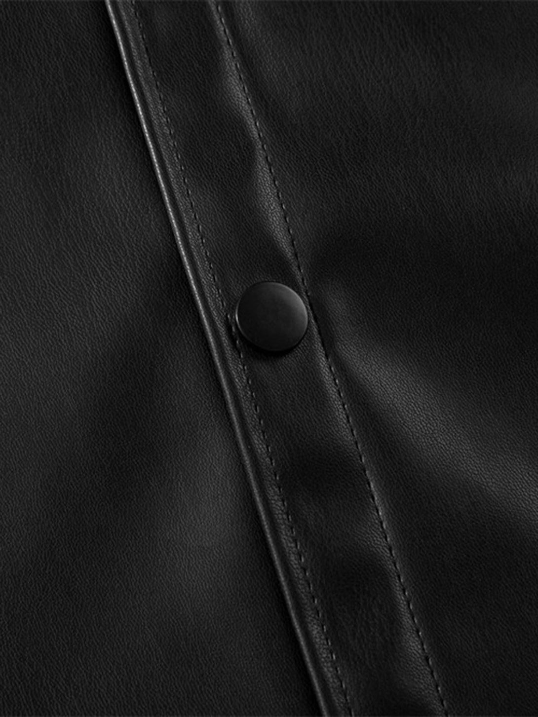 A tight crop highlighting TALISHKO's black PU leather shirt button and sleek stitching details.