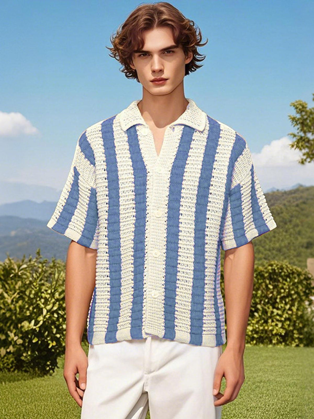 Model wearing a blue and white striped knit cardigan shirt by TALISHKO, set against a lush backdrop.