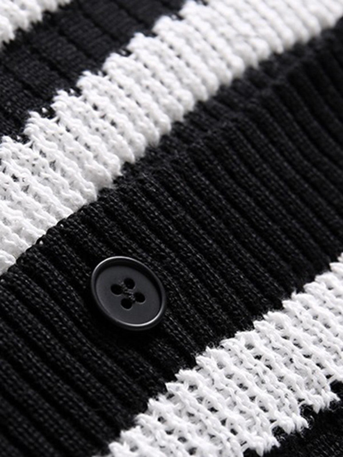 A close-up of the black and white stripe pattern on a TALISHKO knit cardigan shirt, featuring a button detail.