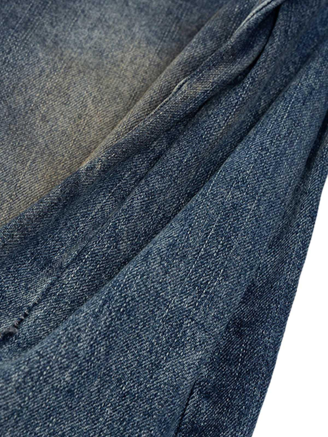 Intricate look at the texture of Cleanfit washed barrel jeans by TALISHKO, highlighting denim detail.