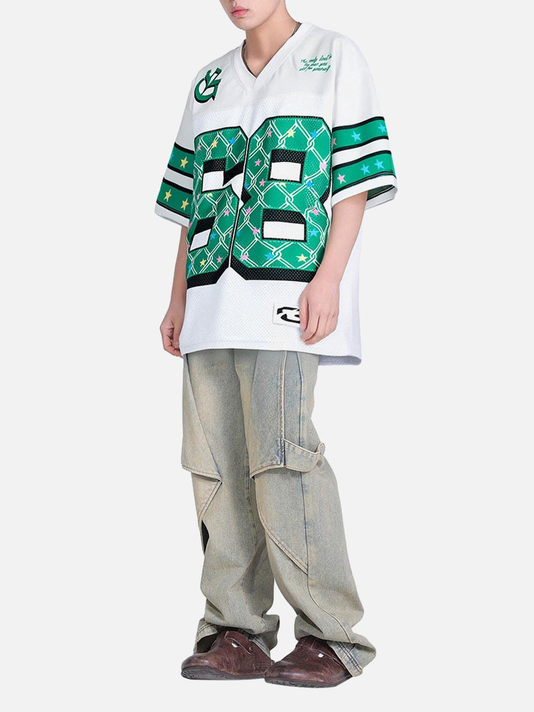 Model wearing TALISHKO Club 68 jersey t-shirt with bold green graphics and loose cargo pants.