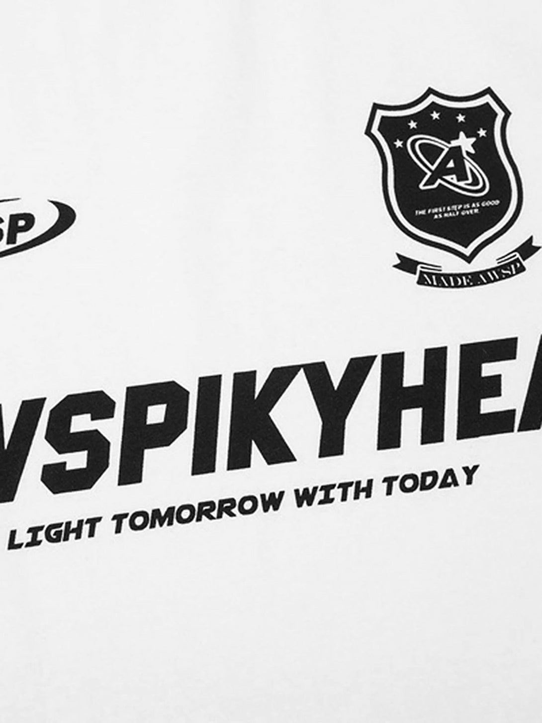 Close-up of TALISHKO T-shirt with bold college-style graphics on white fabric.
