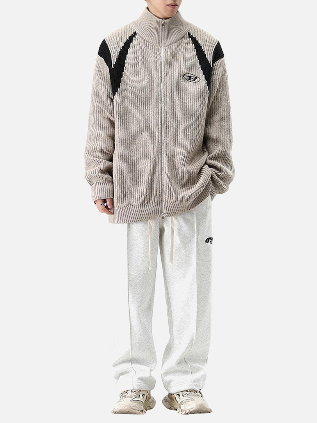 Model in a TALISHKO color block sweater jacket with relaxed fit and casual style.