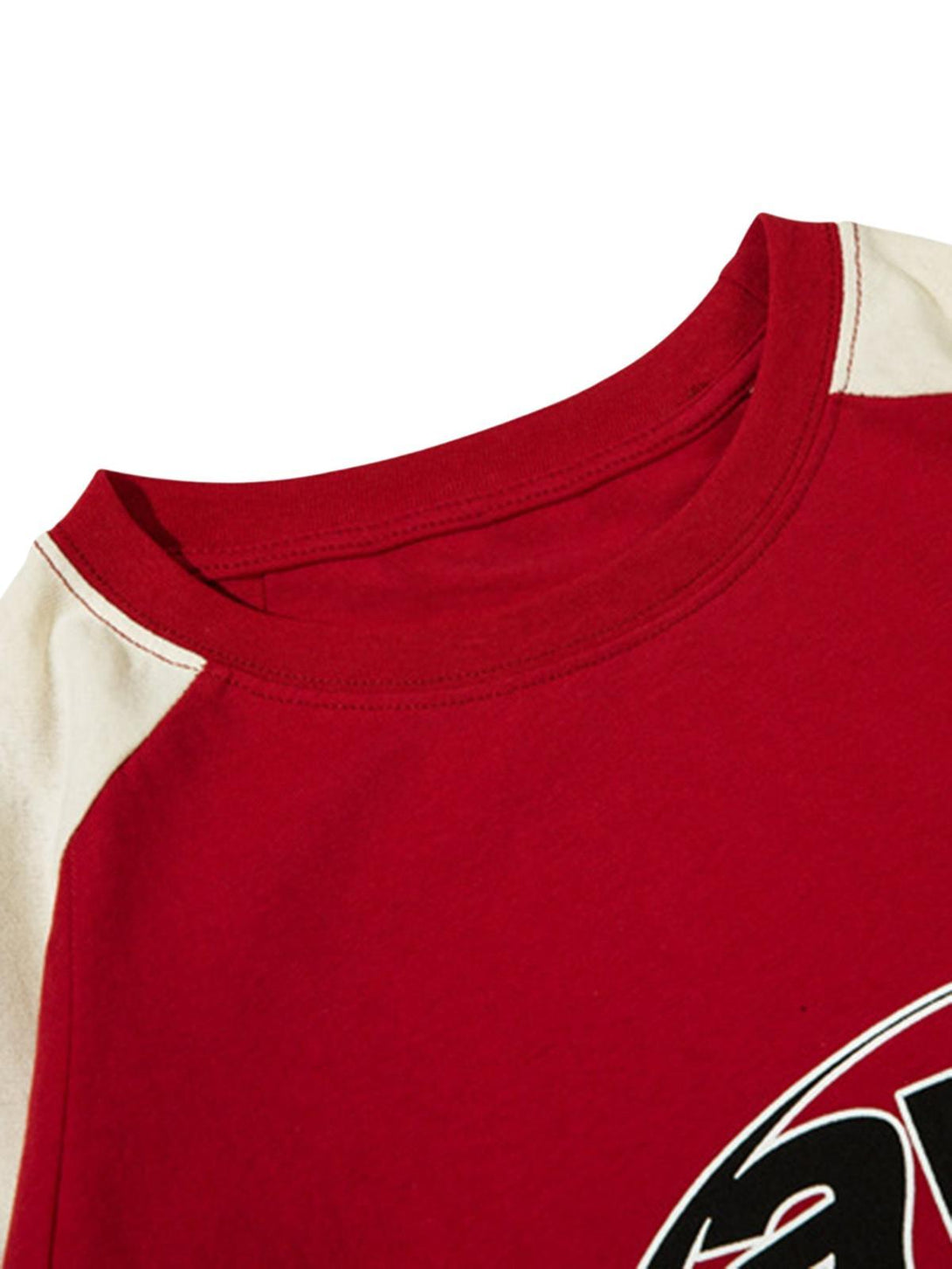 Intricate look at the neckline of a red racing T-shirt by TALISHKO, featuring bold color-block details.